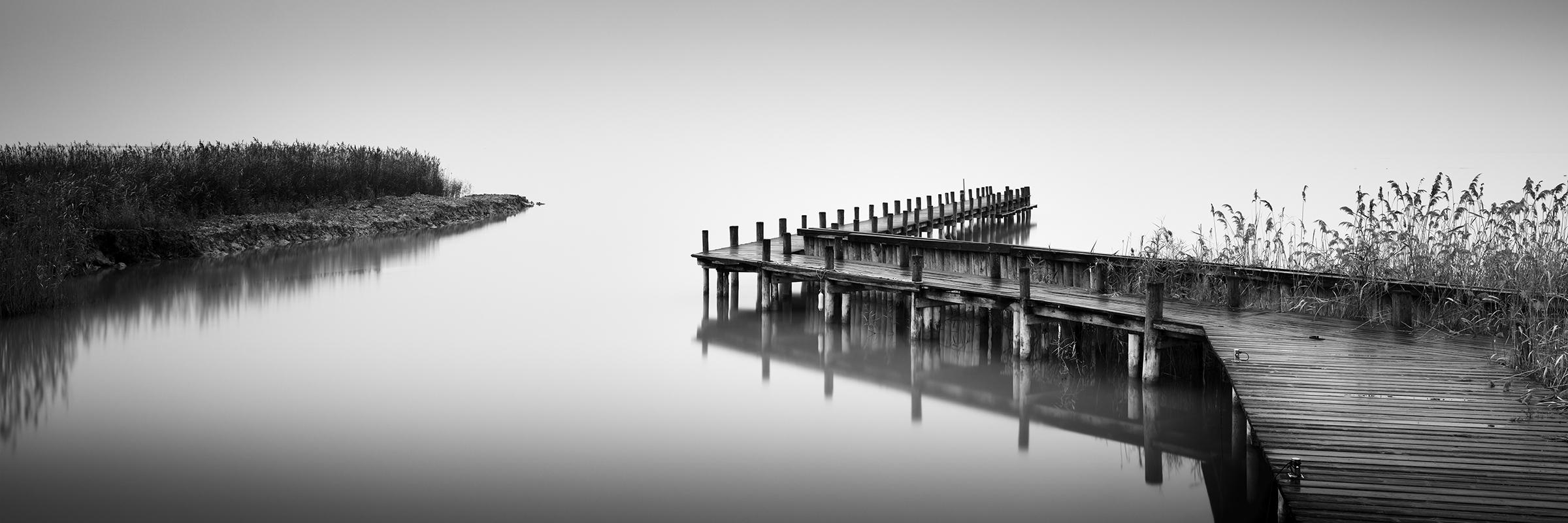 Gerald Berghammer Black and White Photograph - Jetty on calm Lake Panorama, black and white photography, waterscape fine art 