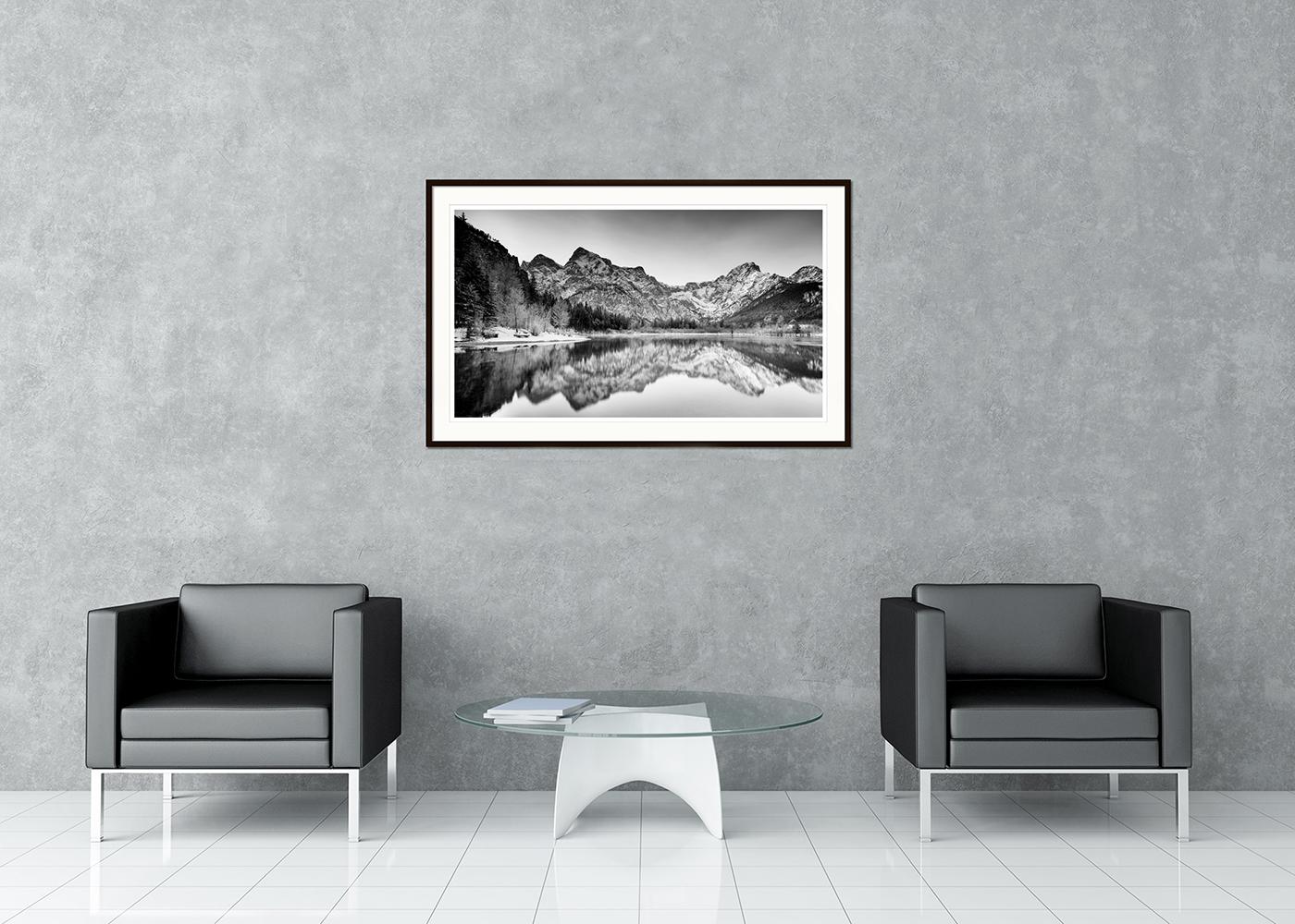 Paisaje acuático panorámico de larga exposición en blanco y negro - fotografía de paisaje. Panorámica invernal junto al lago con montañas, lago y bellos reflejos en el agua, Almsee, Austria. Impresión en tinta de pigmento de archivo, edición de 7.