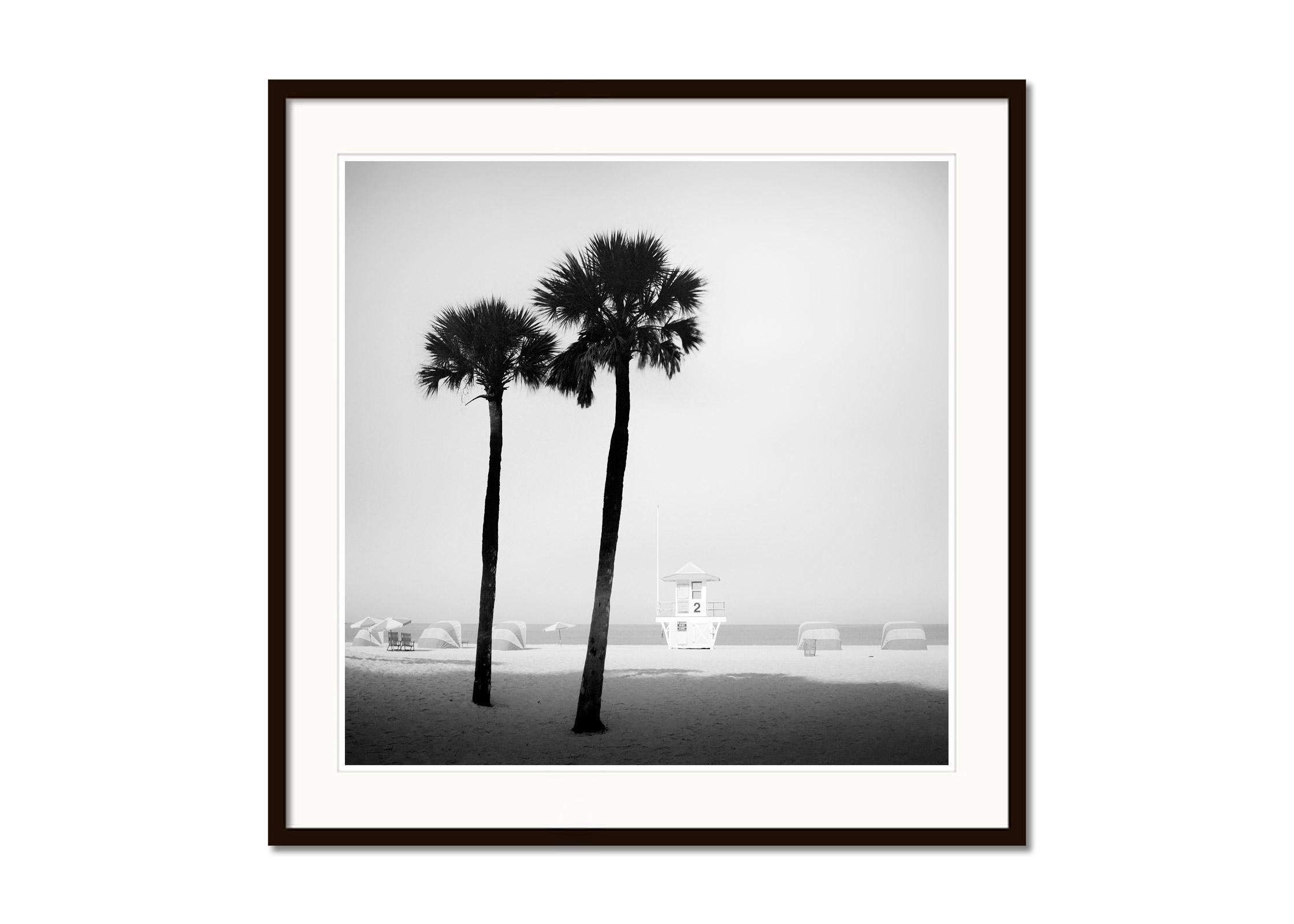 Black and white fine art photography. Lifeguard tower on Miami beach with palm trees and beach chairs, Florida, USA. Archival pigment ink print, edition of 9. Signed, titled, dated and numbered by artist. Certificate of authenticity included.