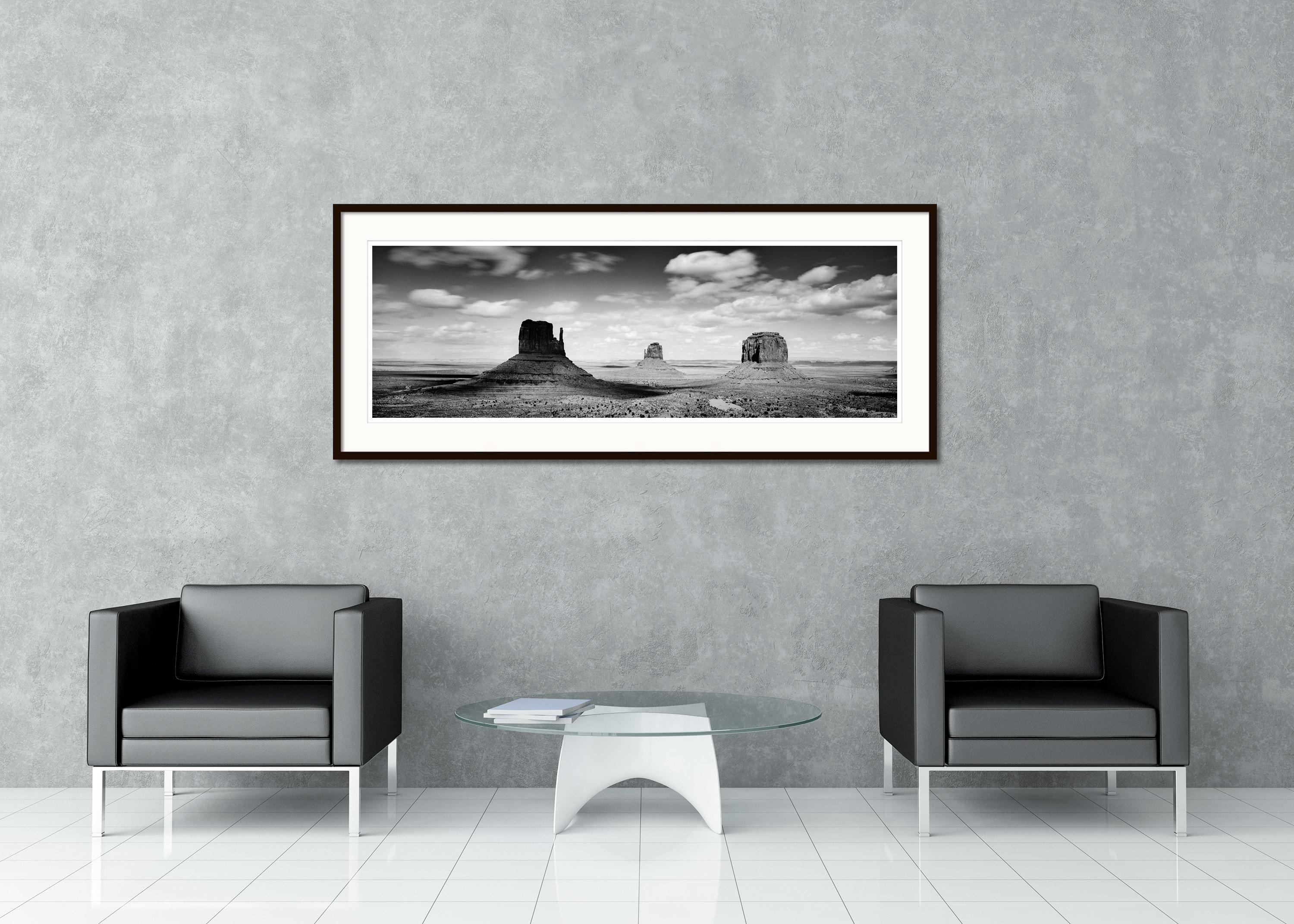 Black and white fine art panorama landscape photography. Monument Valley the famous rocks in the Mojave Desert with beautiful clouds, Navajo Tribal Park, USA. Archival pigment ink print, edition of 9. Signed, titled, dated and numbered by artist.