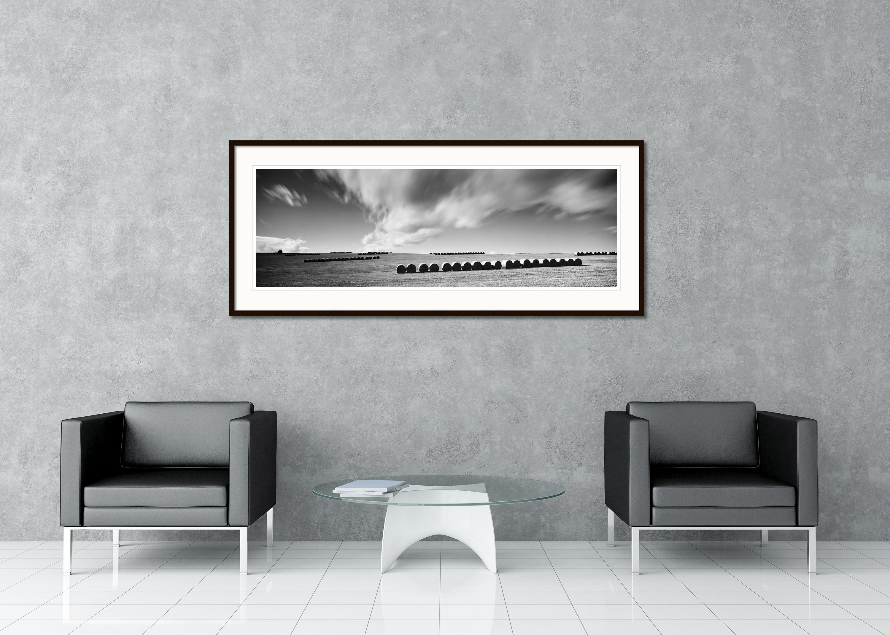 Photographie de paysage panoramique en noir et blanc. Rangée de bottes de paille avec un énorme nuage dans les Highlands d'Écosse. Épreuve à l'encre pigmentaire d'archives, édition de 9 exemplaires. Signée, titrée, datée et numérotée par l'artiste.