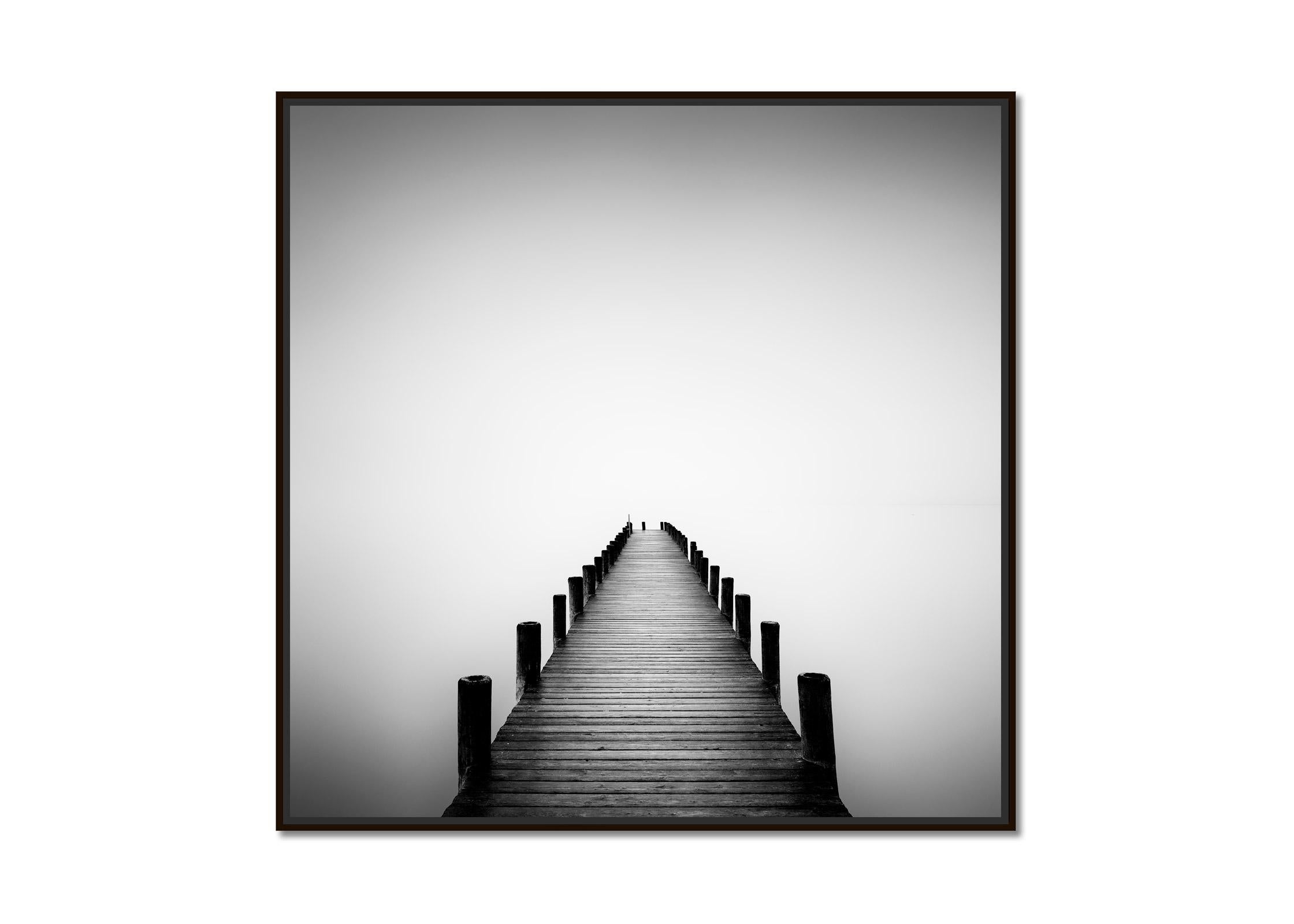 Pier on misty Lake, long exposure, black and white art waterscape photography - Photograph by Gerald Berghammer