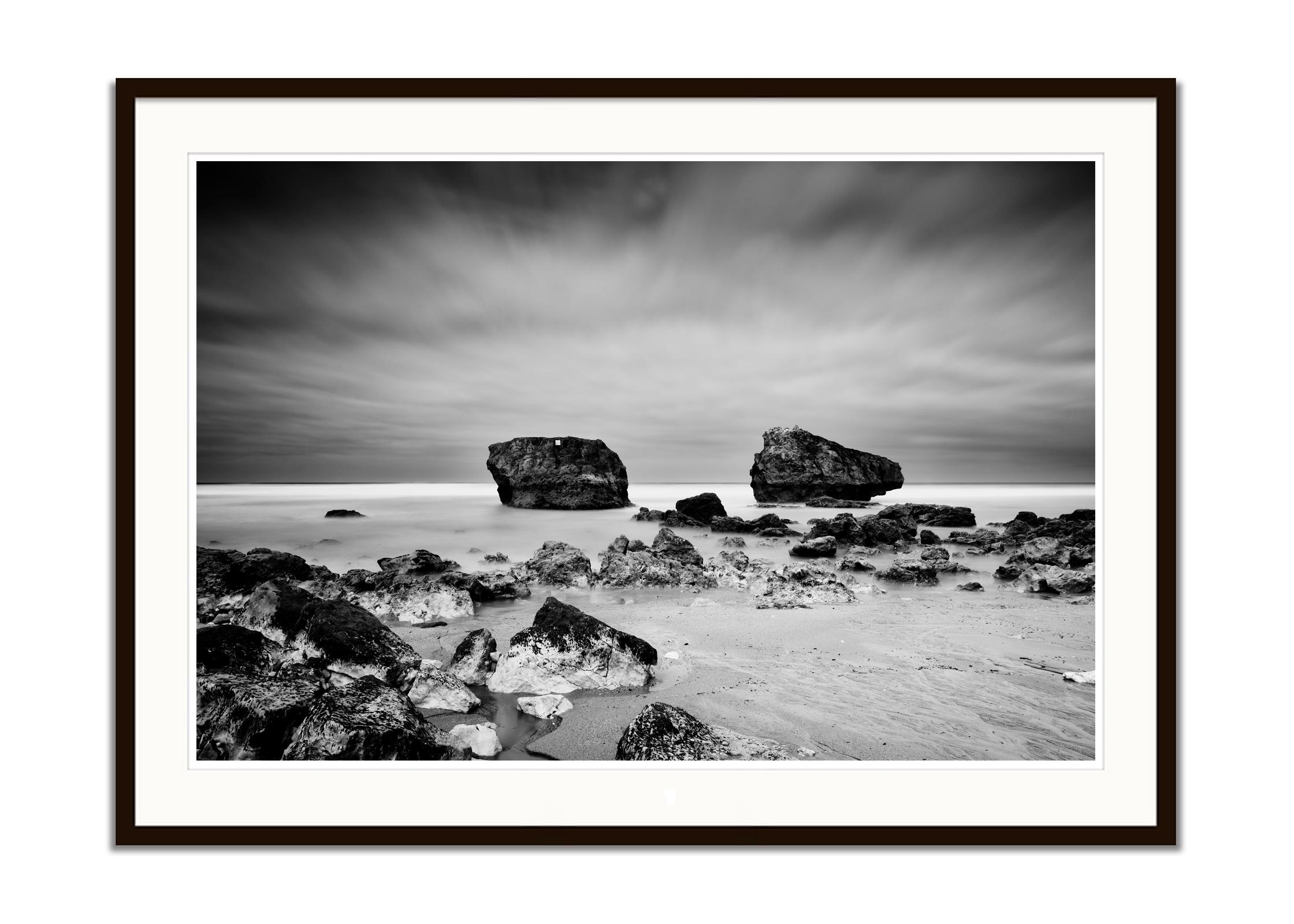 Black and white fine art long exposure waterscape - landscape photography. Giant rocks on the sandy beach of the Atlantic coast in France. Archival pigment ink print as part of a limited edition of 7. All Gerald Berghammer prints are made to order