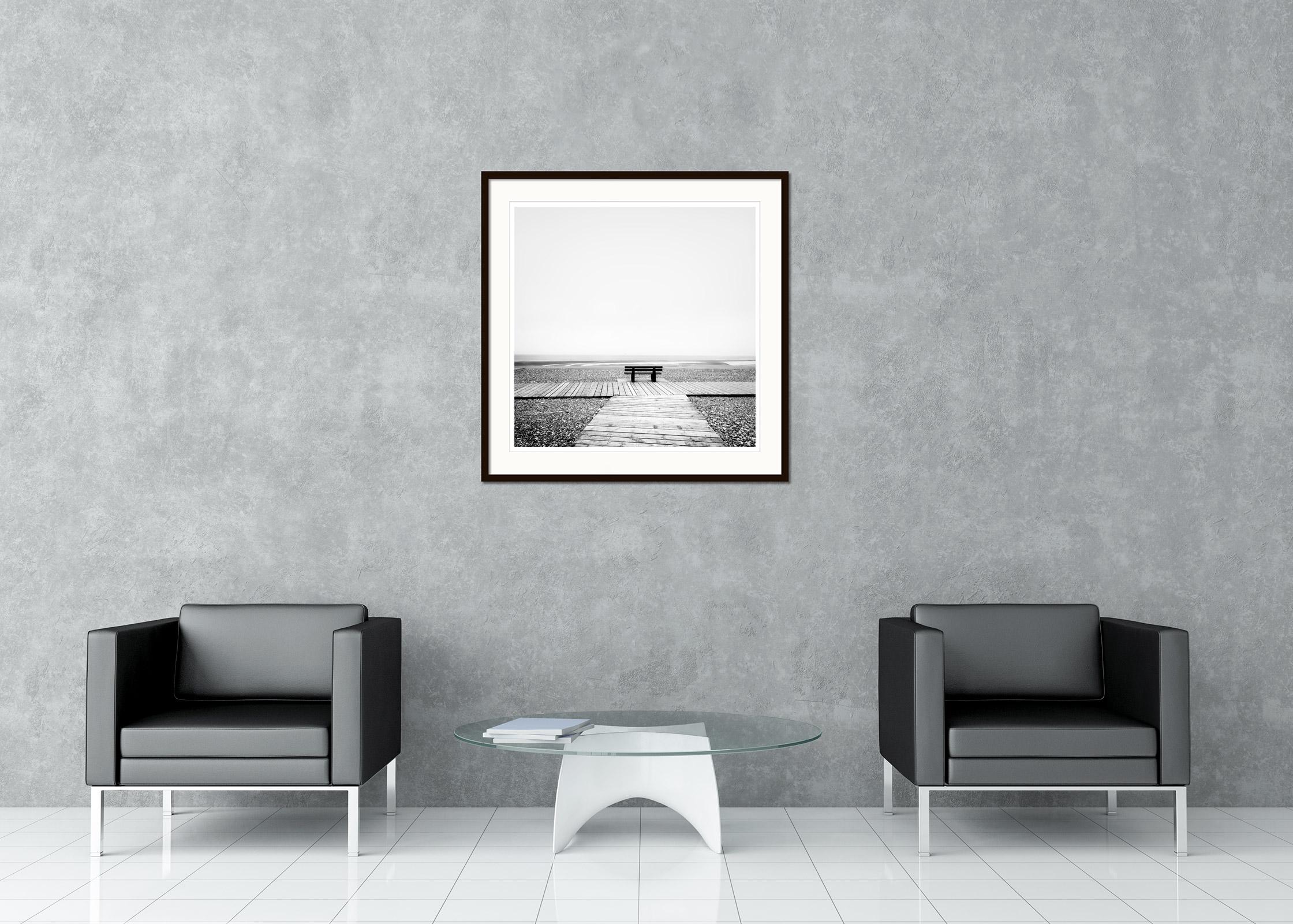 Black and White Fine Art landscape photography. Lonely bench on the deserted stone beach in northern France. Archival pigment ink print, edition of 7. Signed, titled, dated and numbered by artist. Certificate of authenticity included. Printed with