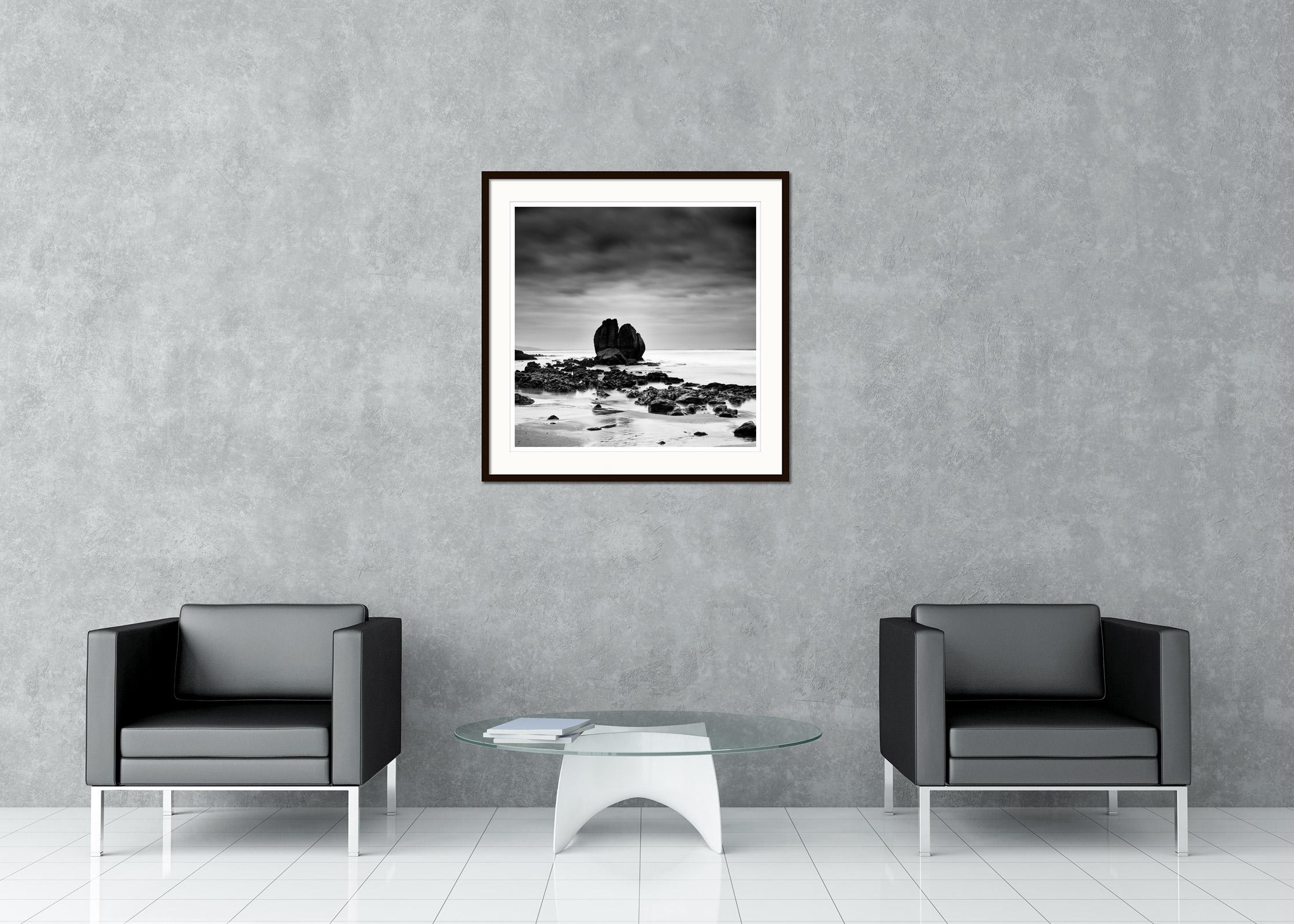 Black and white fine art long exposure waterscape - landscape photography. Rocks on the shore of the beautiful sandy beach on the French Atlantic coast. Archival pigment ink print as part of a limited edition of 8. All Gerald Berghammer prints are