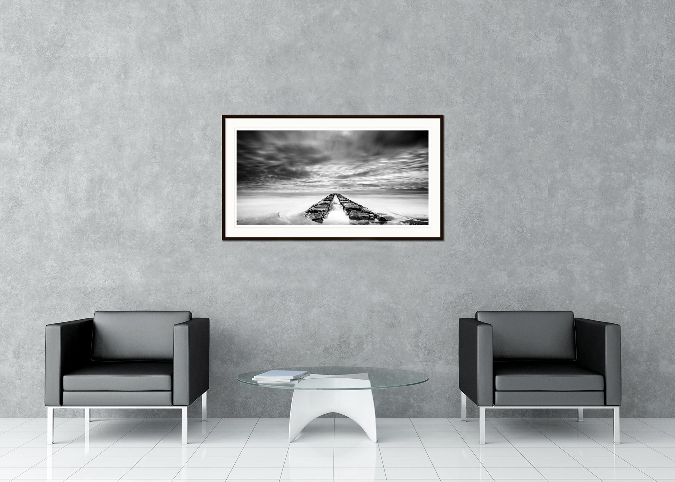 Black and White Fine Art long exposure landscape photography. Rocky Pier in stormy overcast weather on the beach of Italy. Archival pigment ink print, edition of 5. Signed, titled, dated and numbered by artist. Certificate of authenticity included.