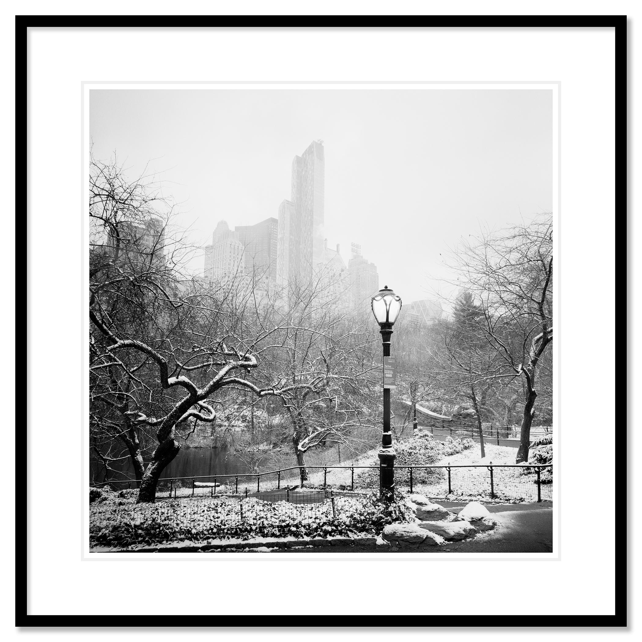 Snow covered Central Park New York City monocome cityscape - Gray Black and White Photograph by Gerald Berghammer