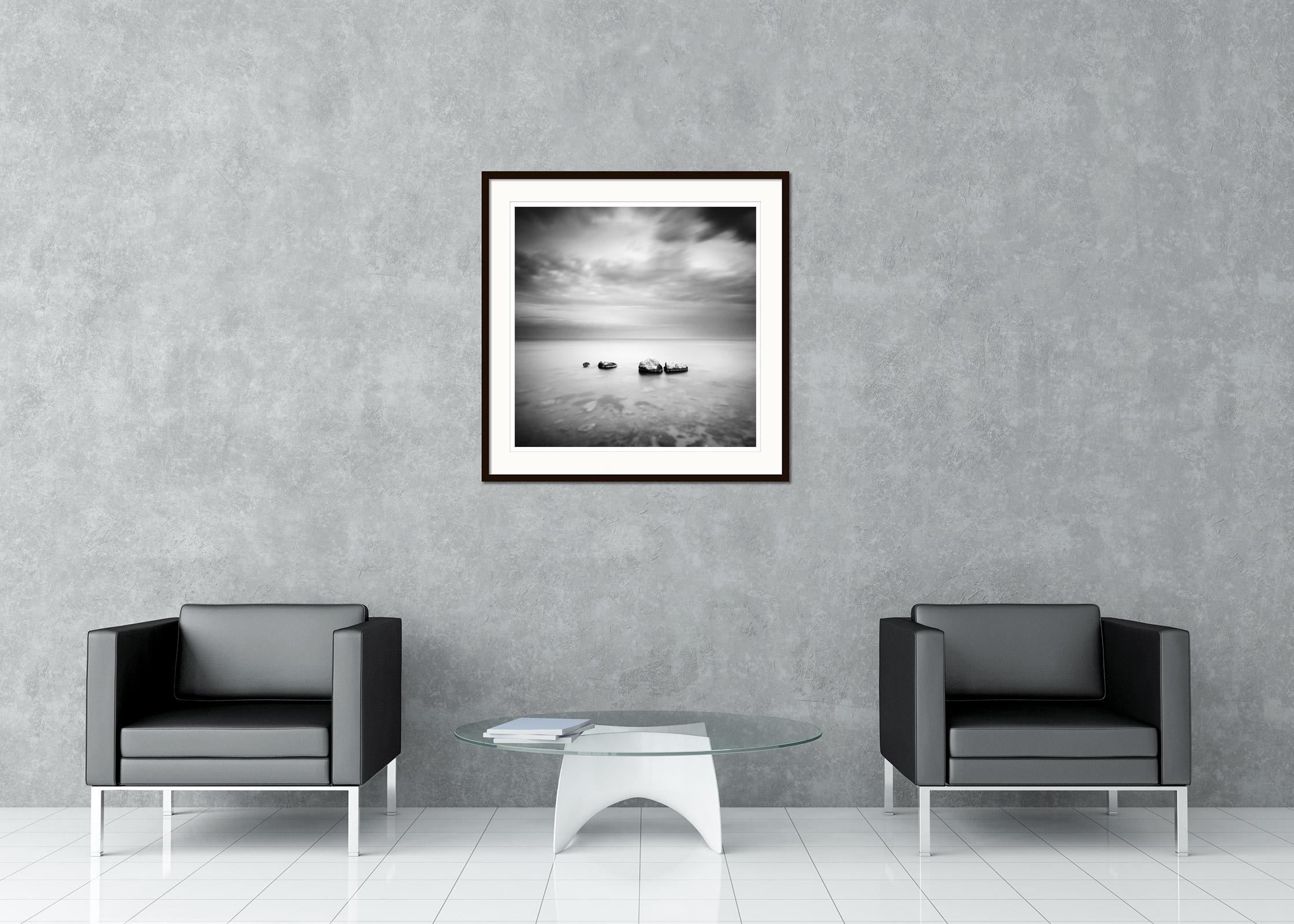 Black and white fine art minimalist seascape - landscape photography. Three stones in the sea during a storm on the coast of Spain. Archival pigment ink print, edition of 9. Signed, titled, dated and numbered by artist. Certificate of authenticity