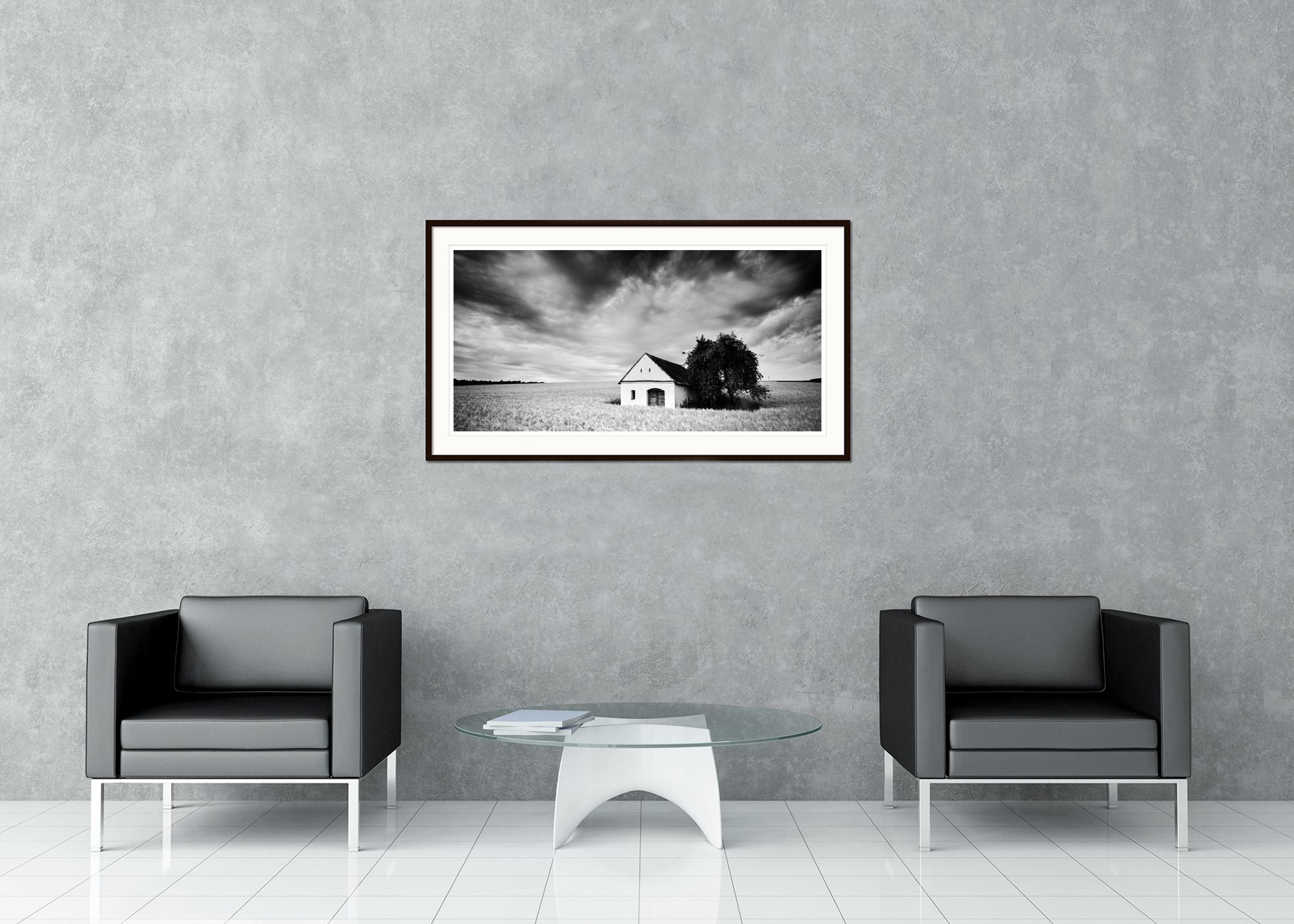 Black and white fine art long exposure landscape photography. Lonely wine press house in the corn field with spectacular clouds, Weinviertel, Austria. Archival pigment ink print, edition of 5. Signed, titled, dated and numbered by artist.