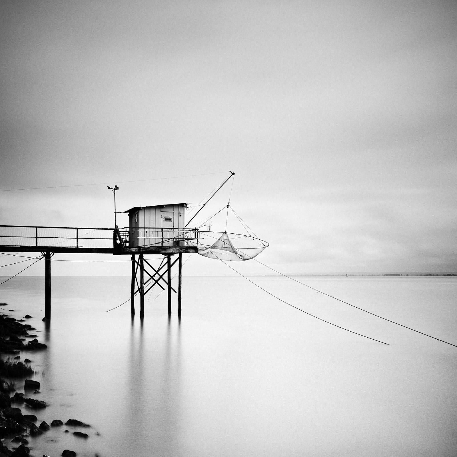 Gerald Berghammer Landscape Photograph - Wooden fishing Hut on Stilts, France, black and white art waterscape photography