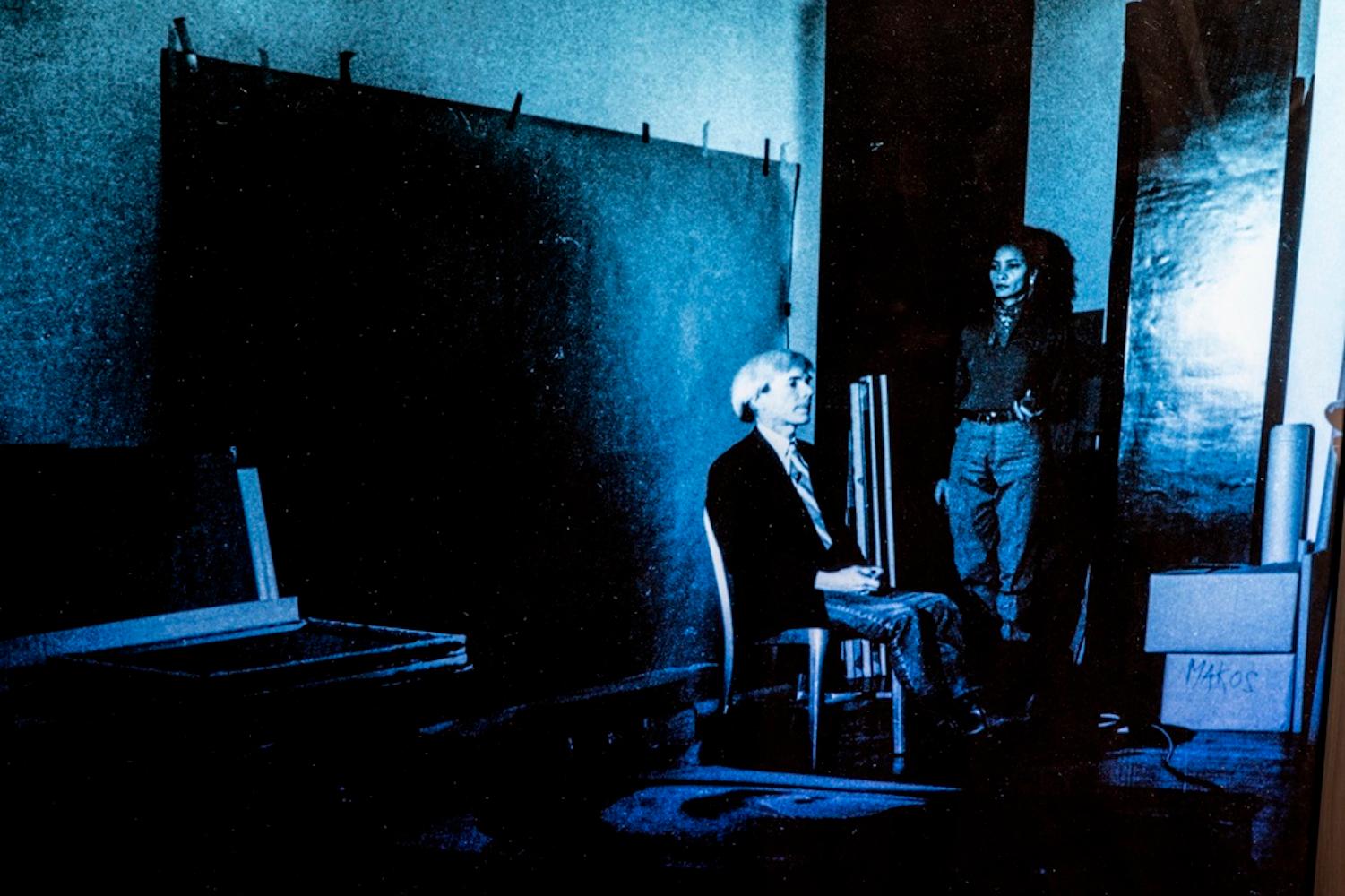 Portrait of Andy Warhol Posing on Blue Background - by G. Bruneau - 1980s - Photograph by Gerald Bruneau
