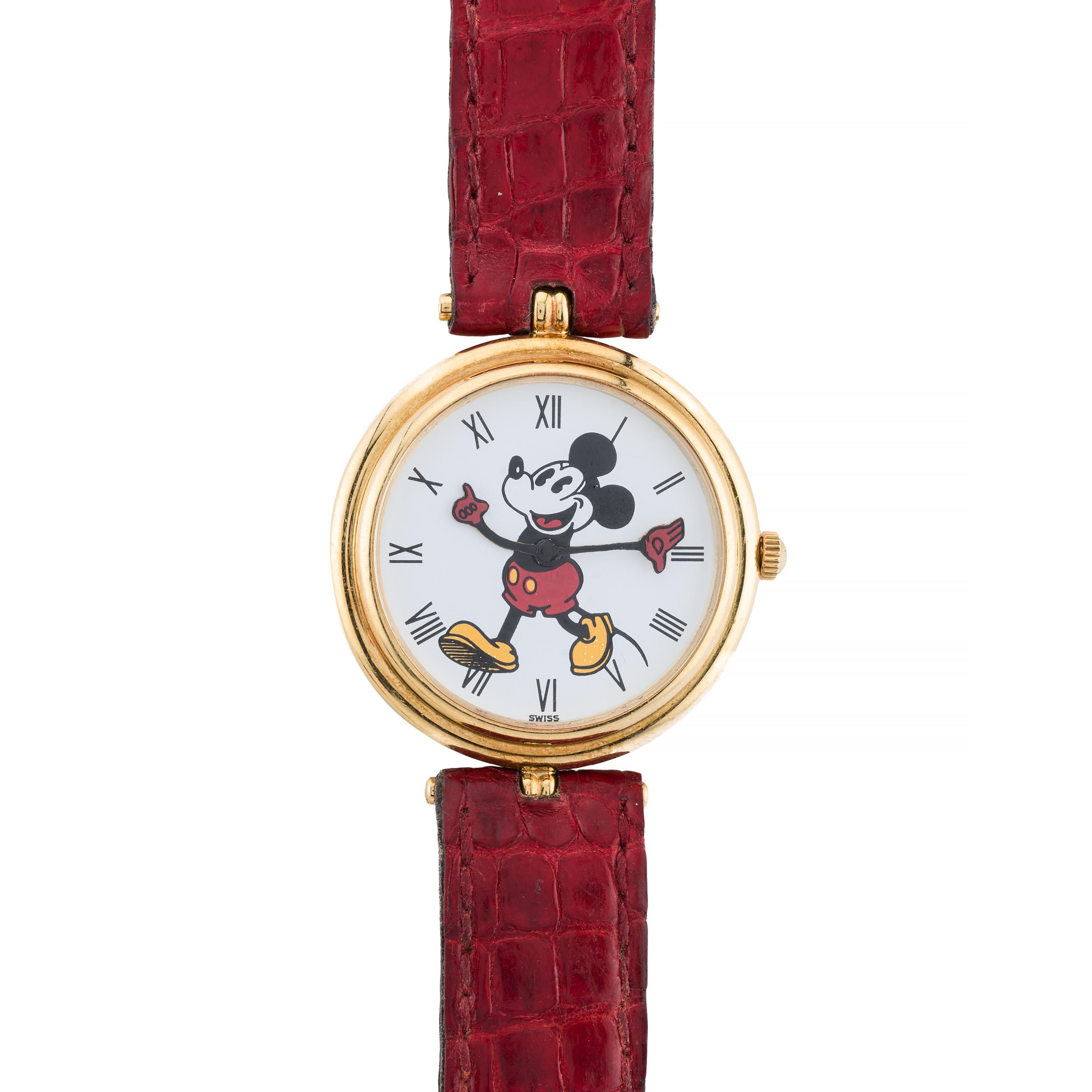 Aston Estate Jewelry Presents:

A Gérald Genta timepiece for Disney, crafted in 18 karat yellow gold, circa 1990. This round watch features a whimsical design with a classic Mickey Mouse character on the dial, using its arms to indicate the time.