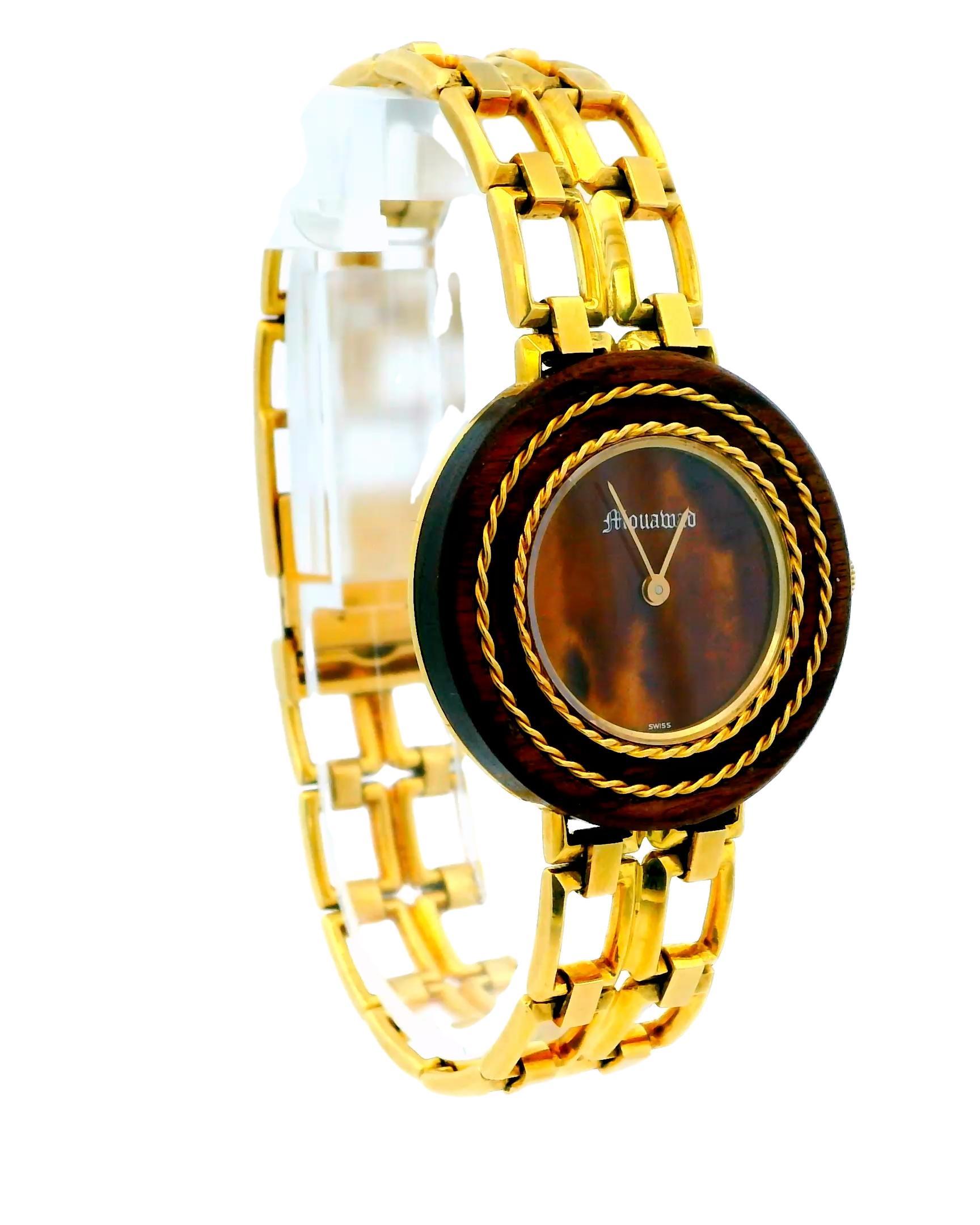A luxurious and elegant watch by Gérald Genta from the 21st century.

This exquisite timepiece features a round case crafted from wood, showcasing a unique and sophisticated design. The manual movement watch has a multicolor dial, adding a touch of