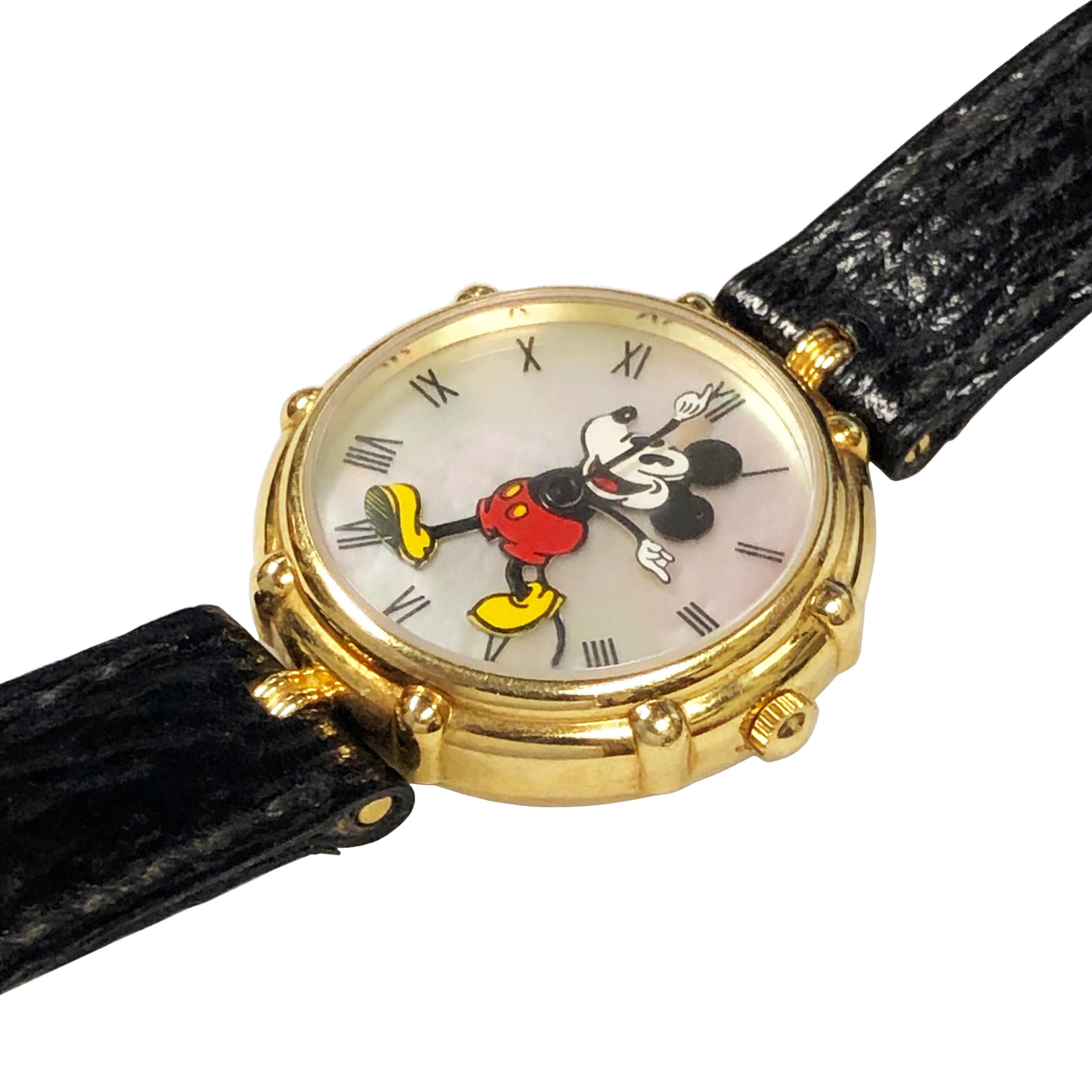 Circa 2000 Gerald Genta Mickey Mouse Wrist Watch, 30 MM 18K Yellow Gold 2 piece water resistant case. Quartz Movement, mother of Pearl Dial with black Roman numerals and an Enamel Mickey Mouse with Animated Hands.  Original Black Stitched Grain