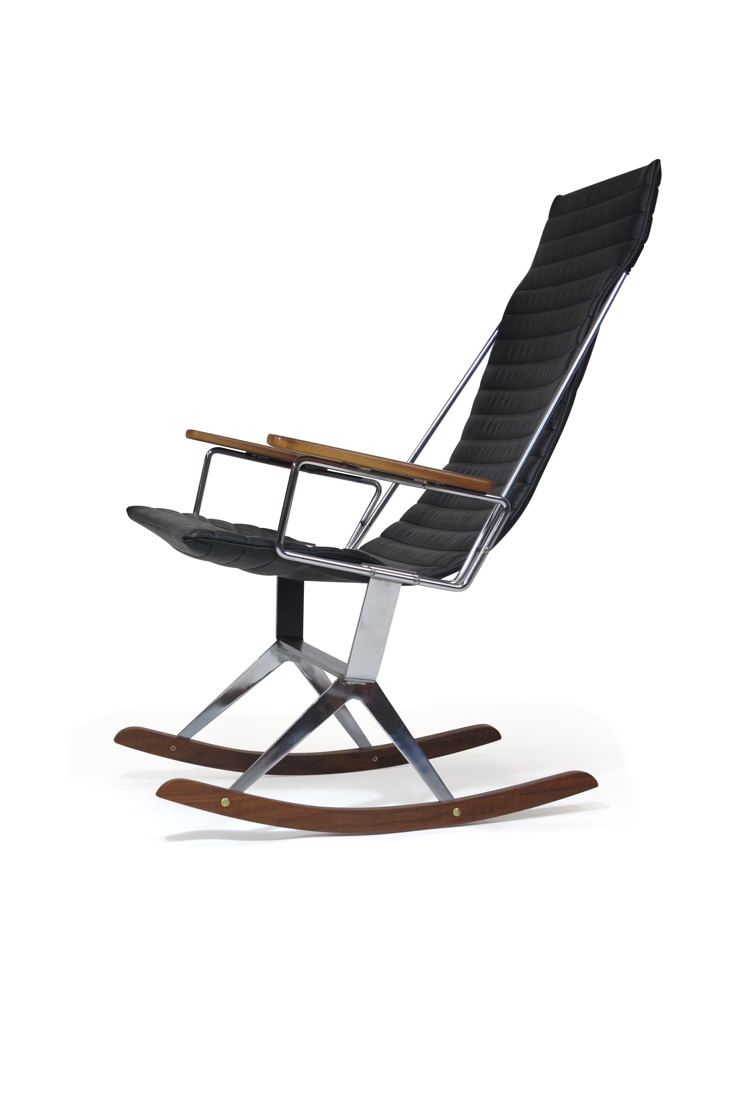 Rocking chair designed by California designer Gerald McCabe for Brown Saltman, circa 1960. The sling seat is upholstered in the original channel backed black vinyl, which slips onto a round bar steel frame with walnut arms. Flat-bar steel frame