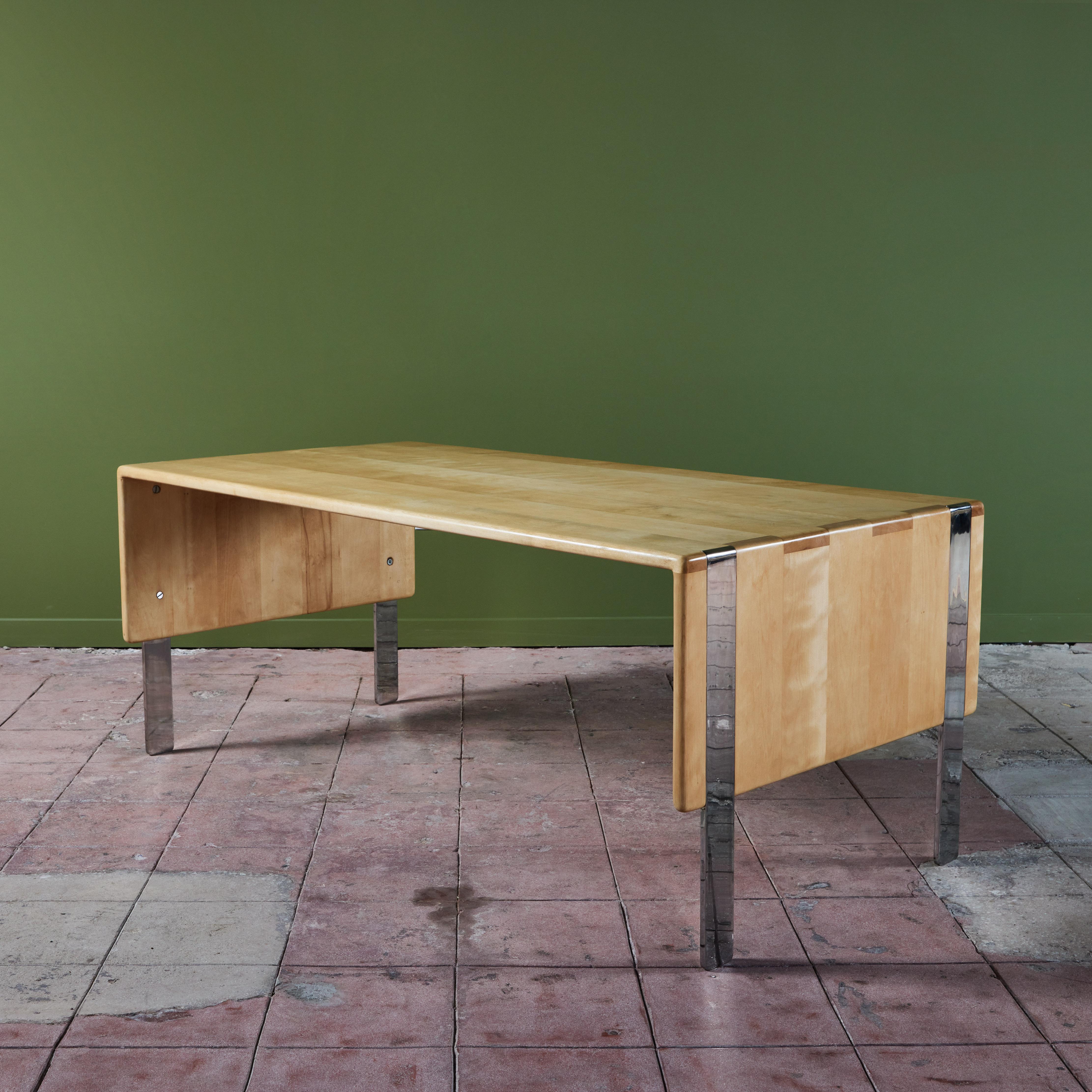 Desk or table by Gerald McCabe for Eon Furniture. The maple table, features soft rounded sides with finger joinery detailing at the edges. The table is supported by four inlayed rectangular chrome legs. 

Dimensions
72