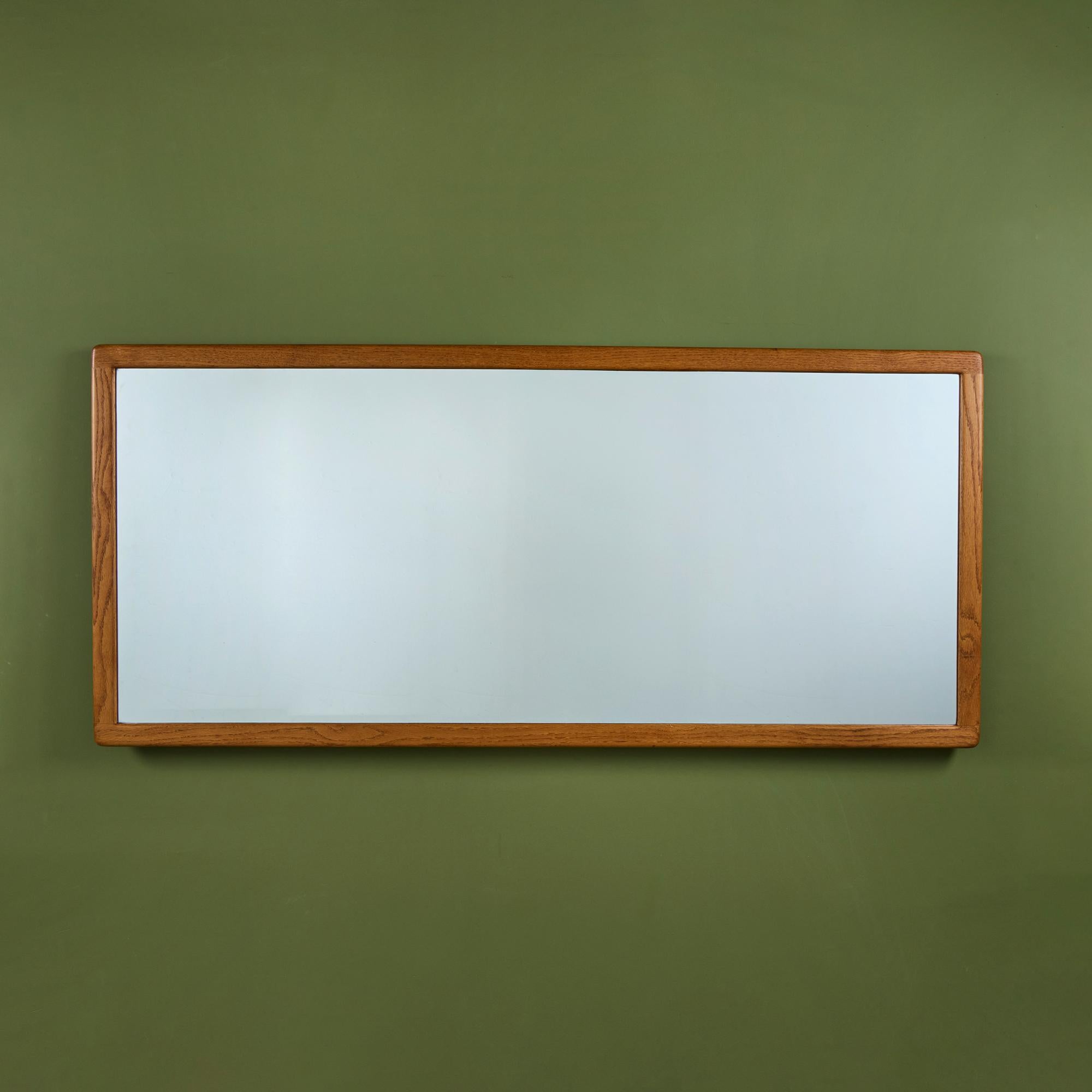 Oak mirror from American designer Gerald McCabe for Eon Furniture, c.1970s. The large scale mirror can be mounted both vertically and horizontally to a wall. Original glass in mirror.

Dimensions
80