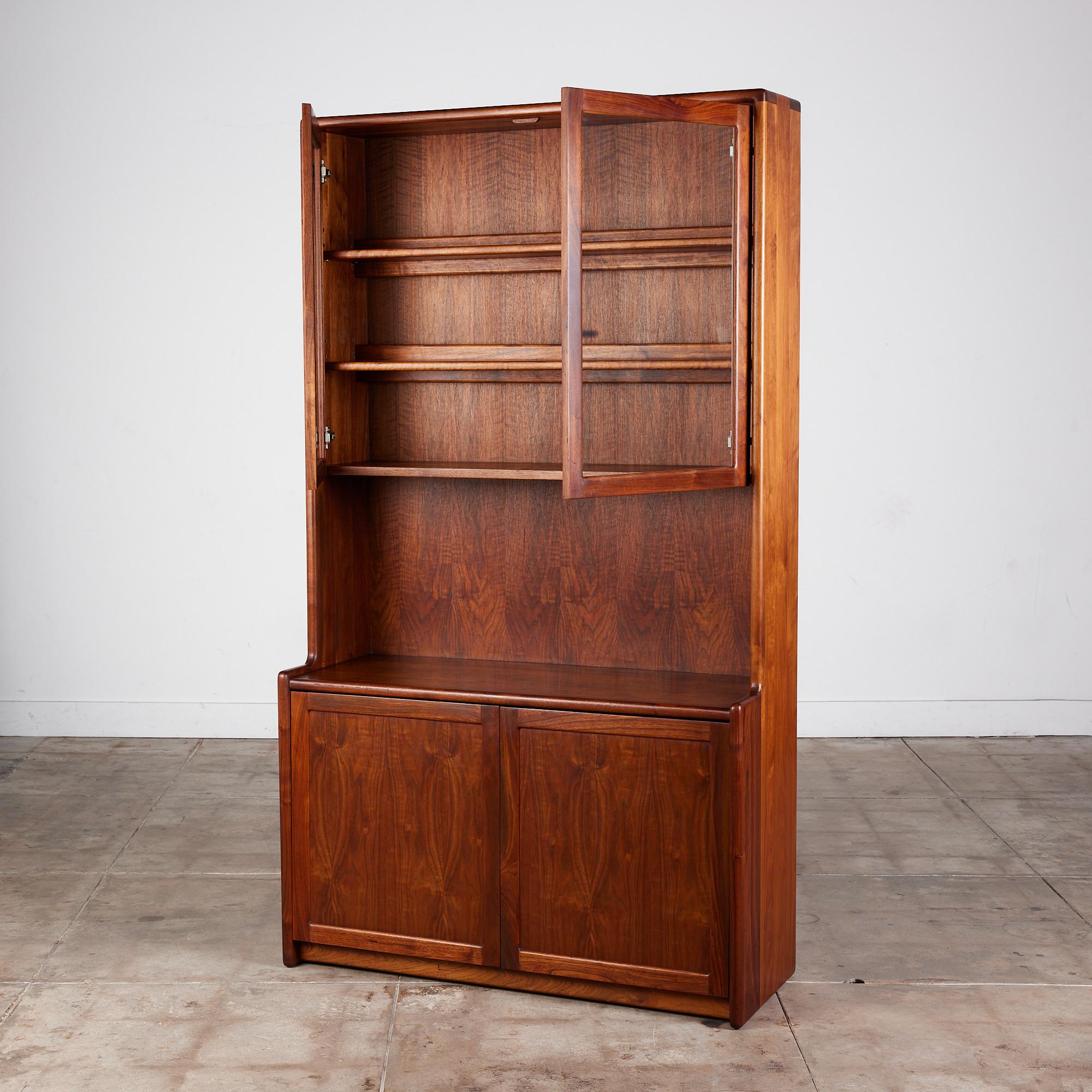 An American made sideboard by Gerald McCabe for Eon Furniture c.1970s, USA. The unique piece is crafted from gorgeous solid Shedua wood, also known as African Walnut. Its rounded edges give the large storage unit a softer feel. The piece features a