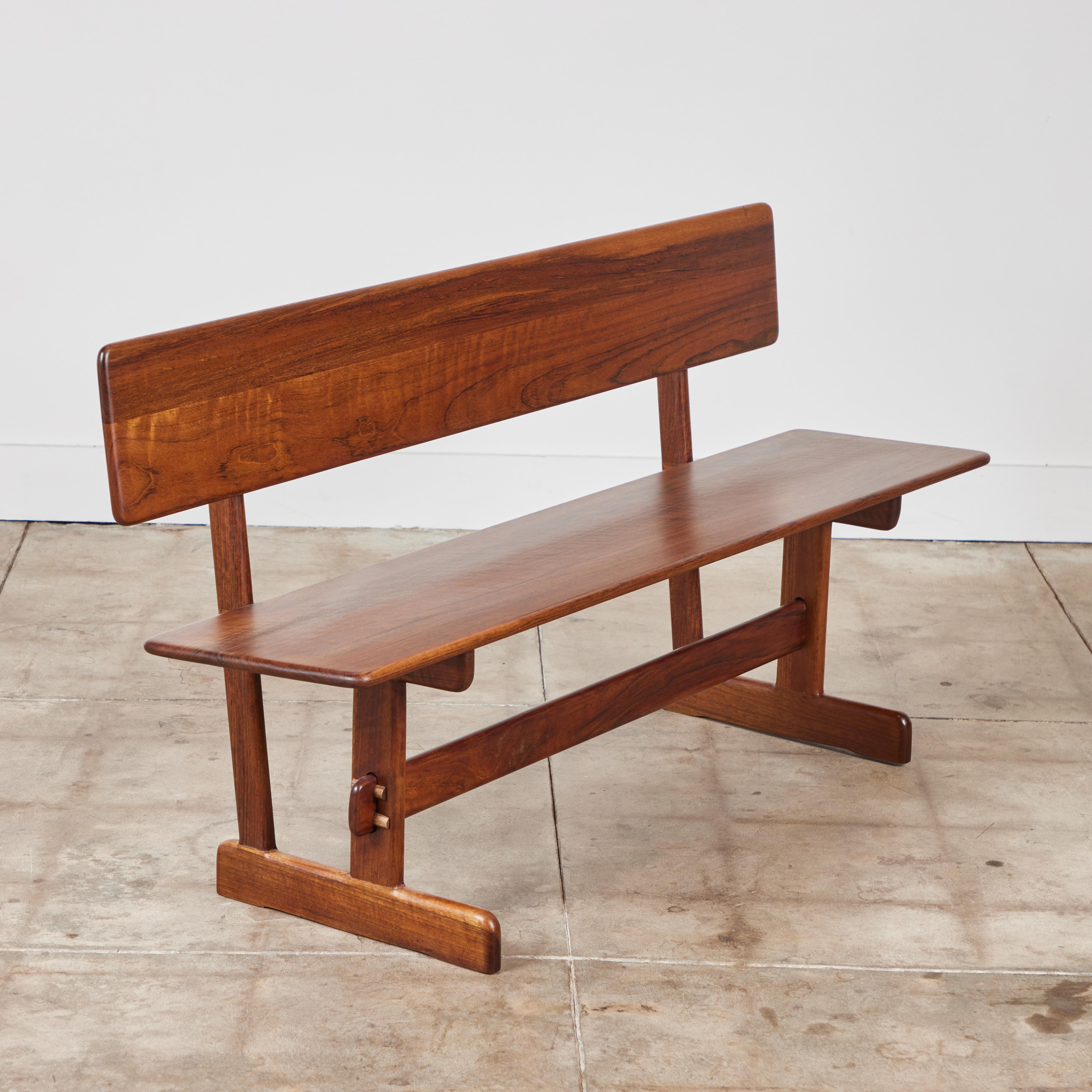 Shedua wood bench from American designer Gerald McCabe for Eon Furniture, c.1970s. The solid wood bench has a long seat with seat back perfect for a dining table or entry way.
Two available.

Dimensions
60