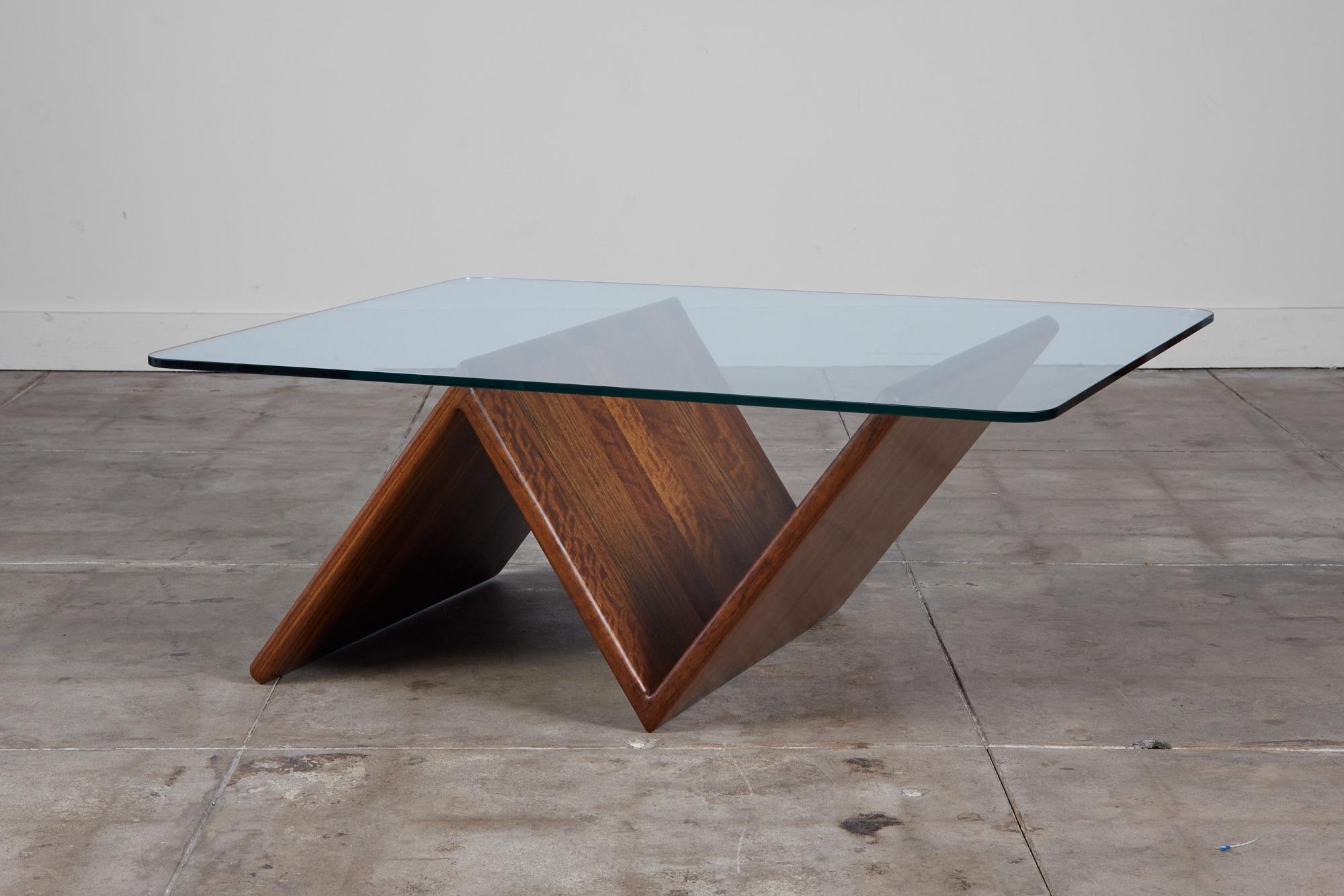 An American made coffee table, c.1970s, by Gerald McCabe. This fun piece is made from stunning solid Shedua. This wood, also known as African Walnut, is joined together using a box joint, which offers a strong structure and lends to a clean please