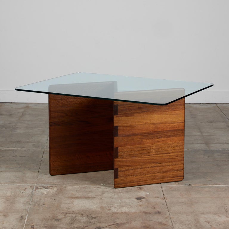 An American made dining table, c.1970s, by Gerald McCabe. This fun piece is made from stunning solid Shedua. This wood, also known as African Walnut, is joined together using a box joint, which offers a strong structure and lends to a clean please