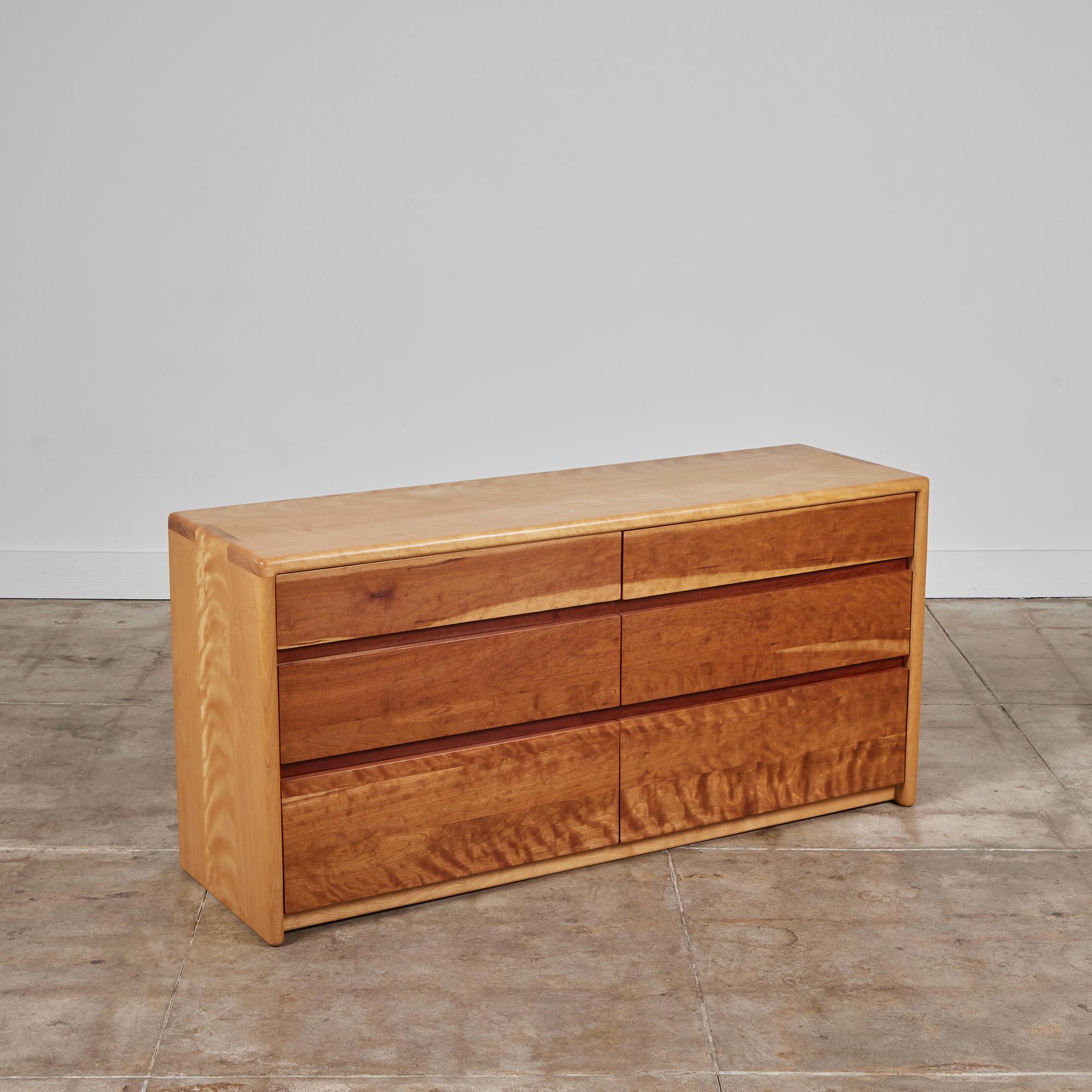 Dresser by Gerald McCabe for Eon Furniture, c.1997, USA. The maple framed wood dresser, features soft rounded edges with finger joint detailing at the edges. The six flat front drawers feature shedua wood. This piece is personally signed by McCabe