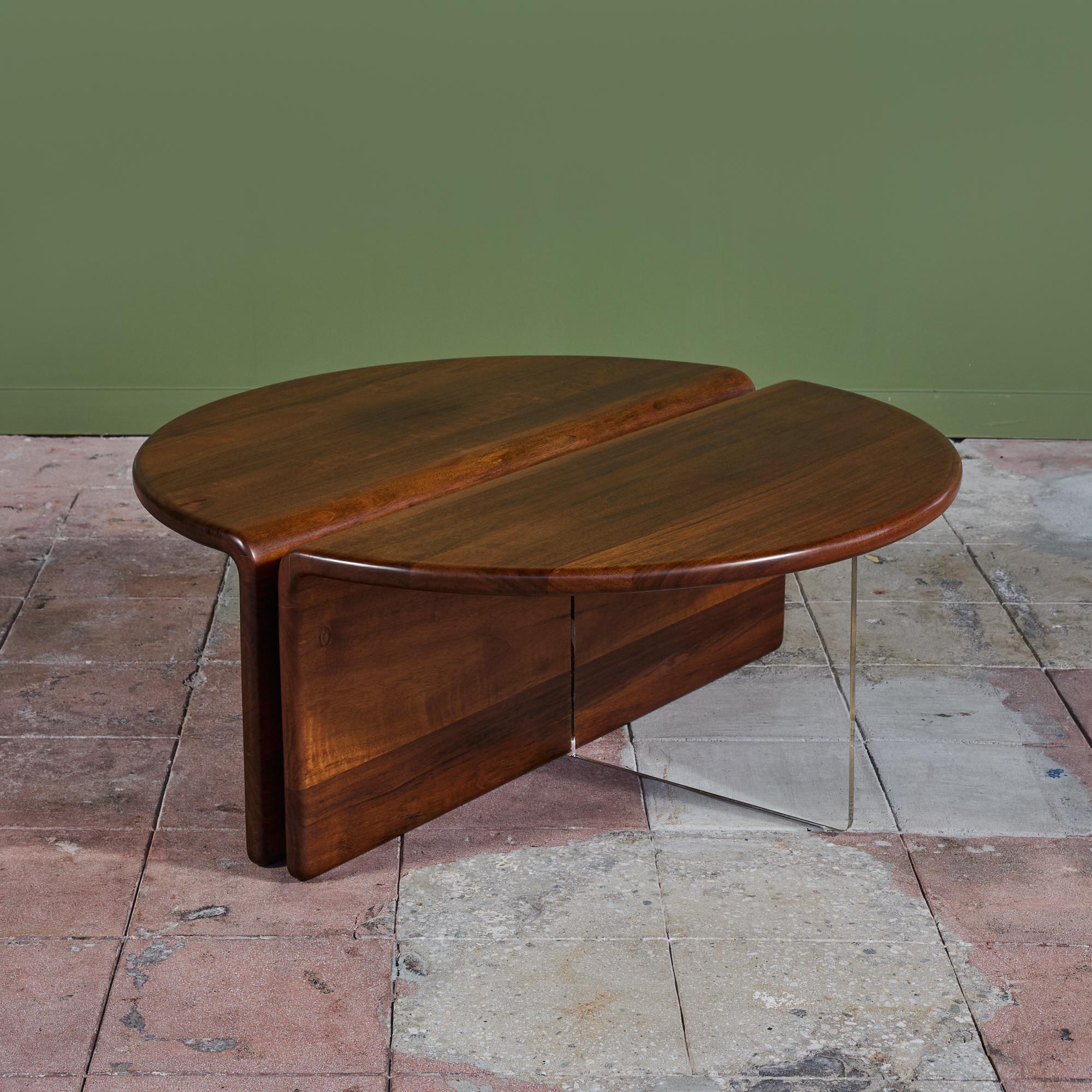 An American made coffee table, c.1970s, by Gerald McCabe is beautifully crafted from a solid slab of Shedua. The piece features two semi circular tables that sit side by side to form a circle or can be placed in juxtaposition for a fun look. The