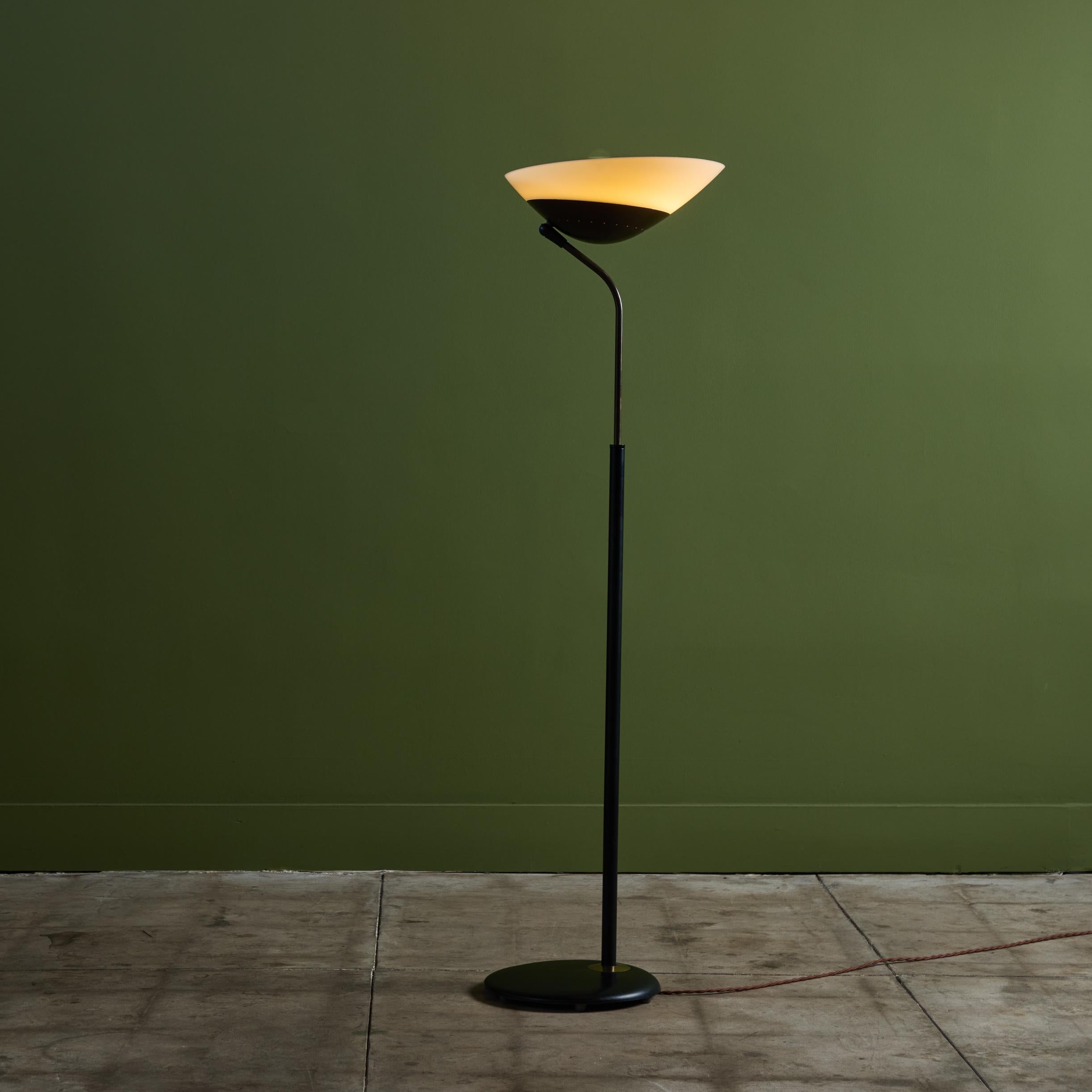 Floor lamp by Gerald Thurston for Lightolier, C.1950s, USA. Distinguished by its unique pivoting shade, this lamp provides both an up light and directional lighting. The shade is connected to the base by an extendable stem in both brass and black