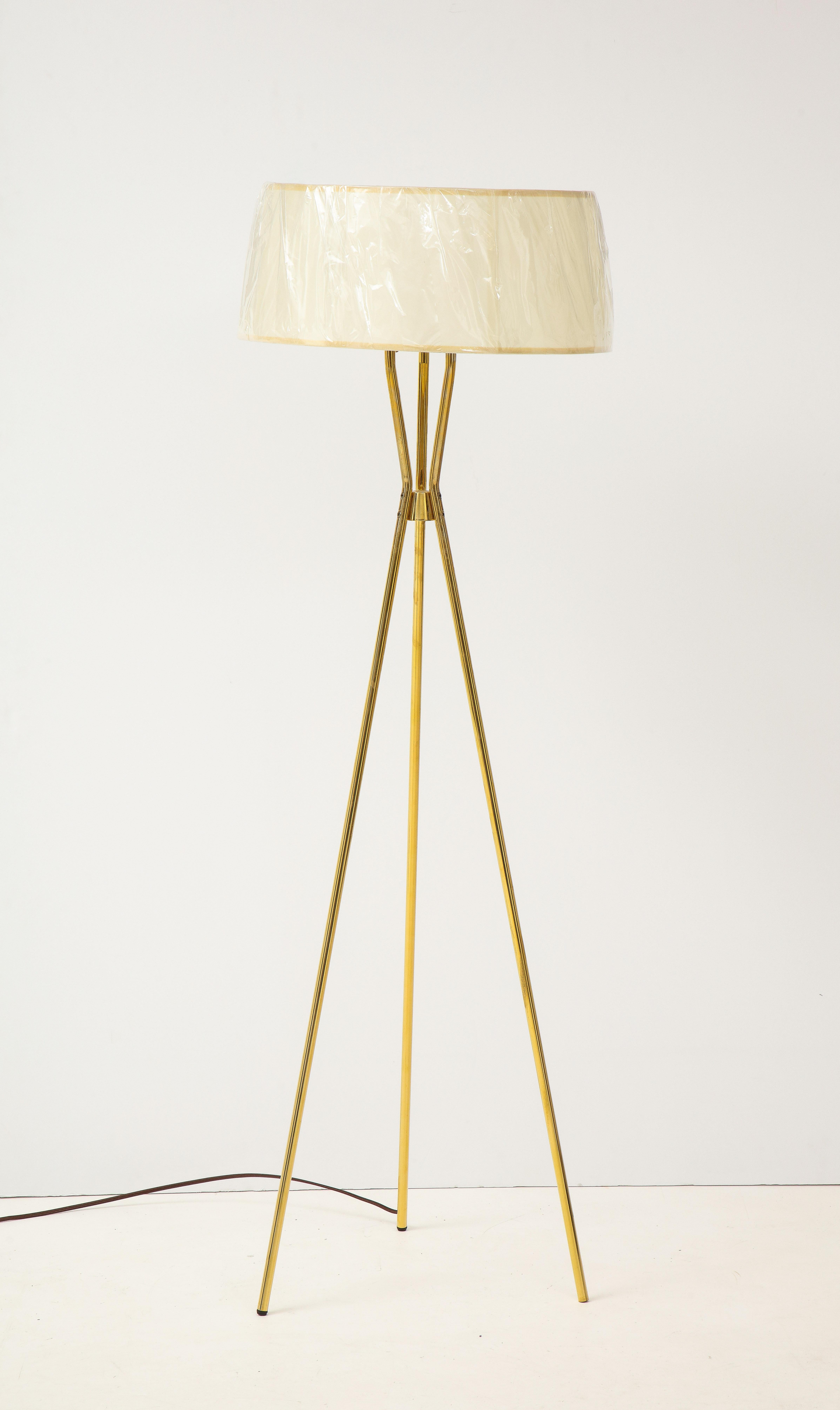Mid-century classic streamlined brass tripod floor lamp with linen shade. Some patina to brass, professionally rewired for use in the USA. Lamp uses 3 bulbs.
Shade not included. Shade depicted measures 15 inch diameter at top, 17 inches in diameter