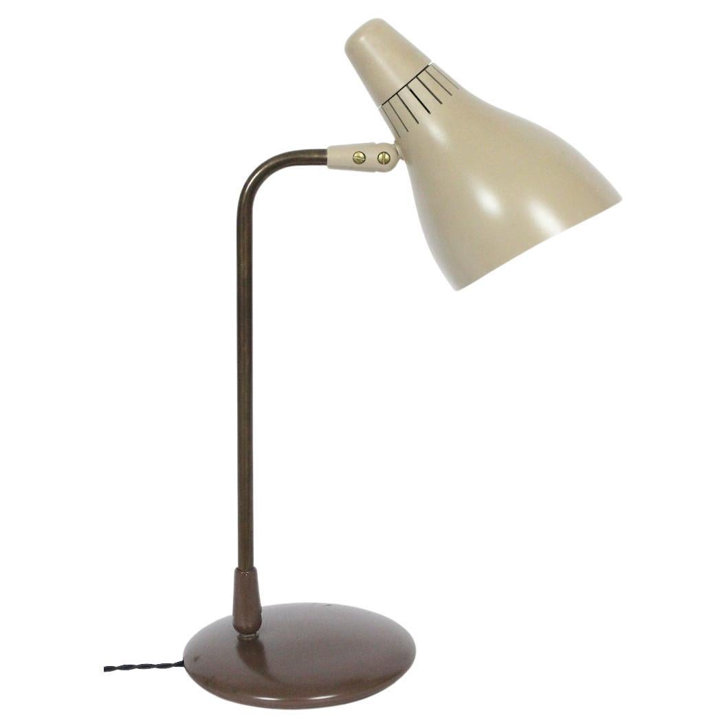 Original condition Gerald Thurston for Lightolier Pivoting Library lamp, 1950's. Featuring an articulating patinated Brass stem, resembling a smooth Bronze appearance, adjustable Taupe Bakelite cone shade with Black edged White interior, a top a