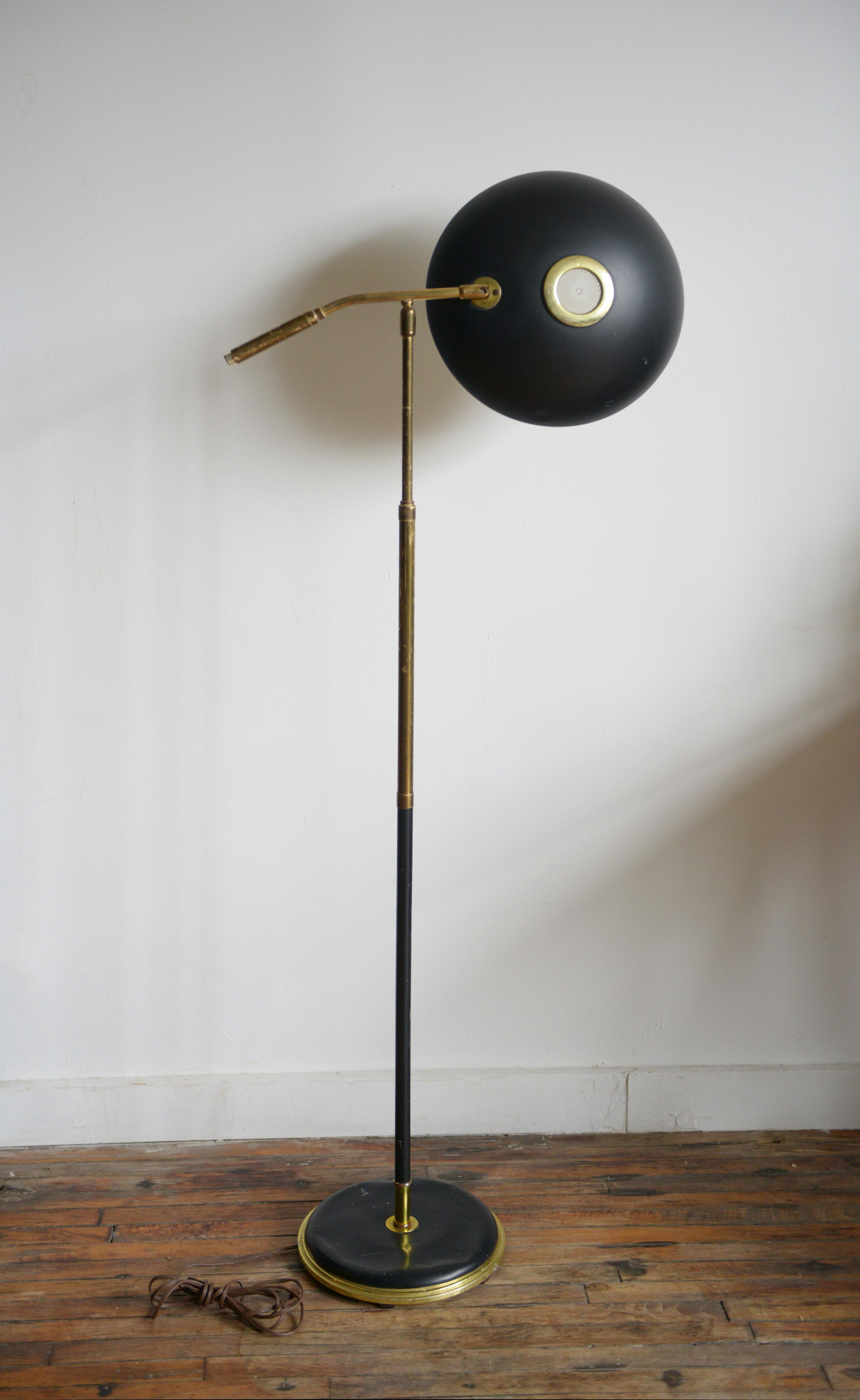 This is one classic reading floor lamp by Gerald Thurston for Lightolier 1950s. Also called the “Saucer“ floor lamp because of its shade’s shape. This particular lamp is constructed out of brass with shade and base in black lacquer. What a beautiful