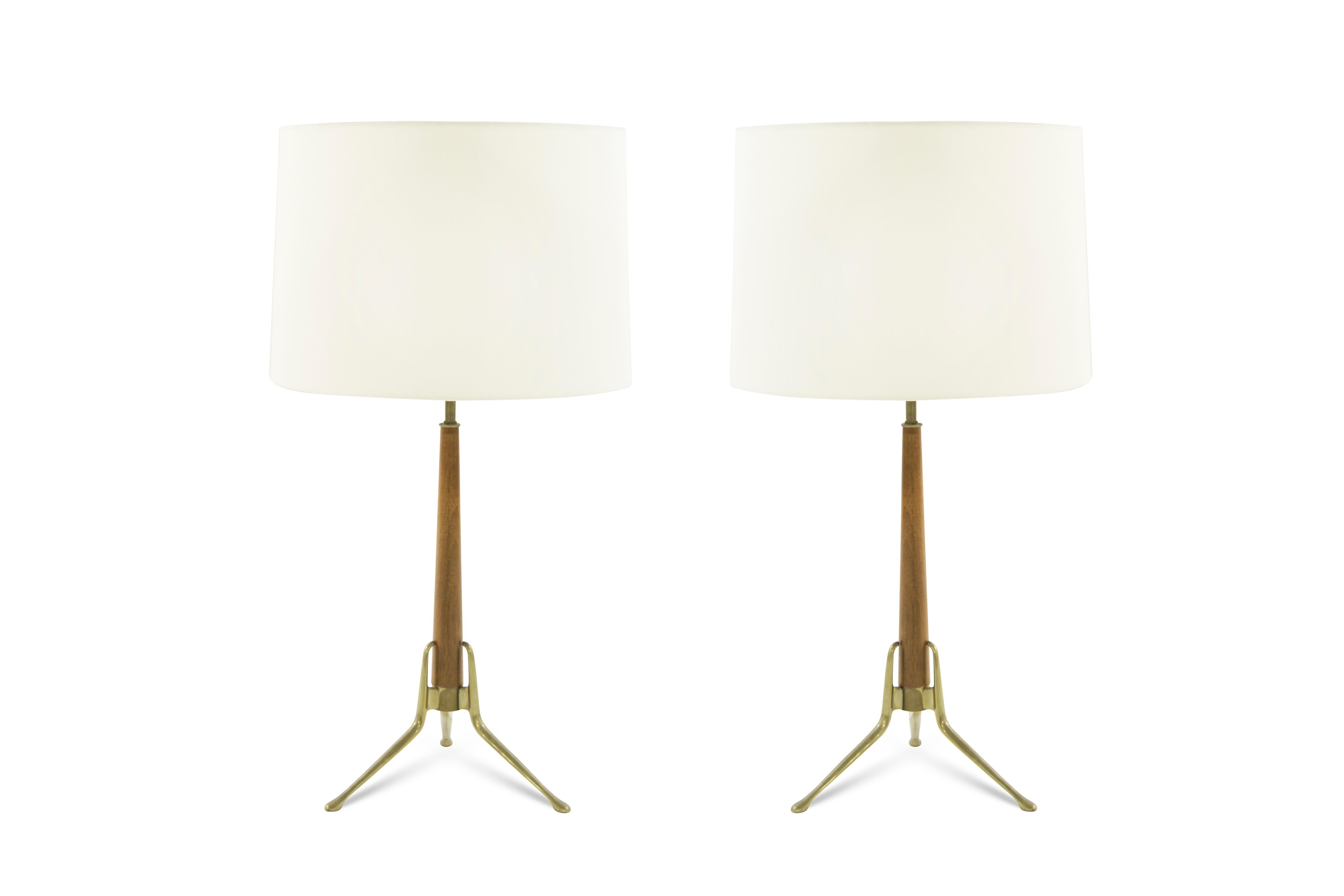 Set of walnut table lamps on brass tripod bases designed by Gerald Thurston for Lightolier, circa 1950s.

Fully rewired.
