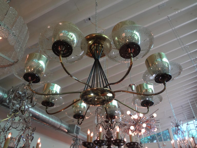 Rare large Mid-Century Modern chandelier by Gerald Thurston for Lightolier. This stunning modernist chandelier is comprised of a brass and iron frame, large glass bobeches and brass cups. This unusual fixture has been newly wired and can be