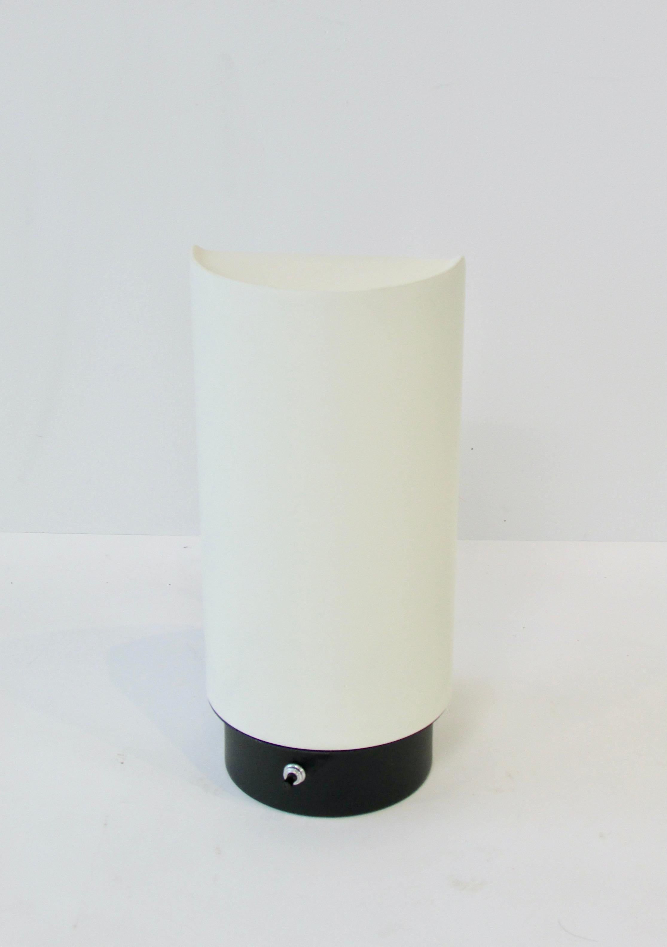 White lacquer cylinder form with pie slice opening on backside. Design by Gerald Thurston for Lightolier. Lamp appears to be as new. Retains both original labels.