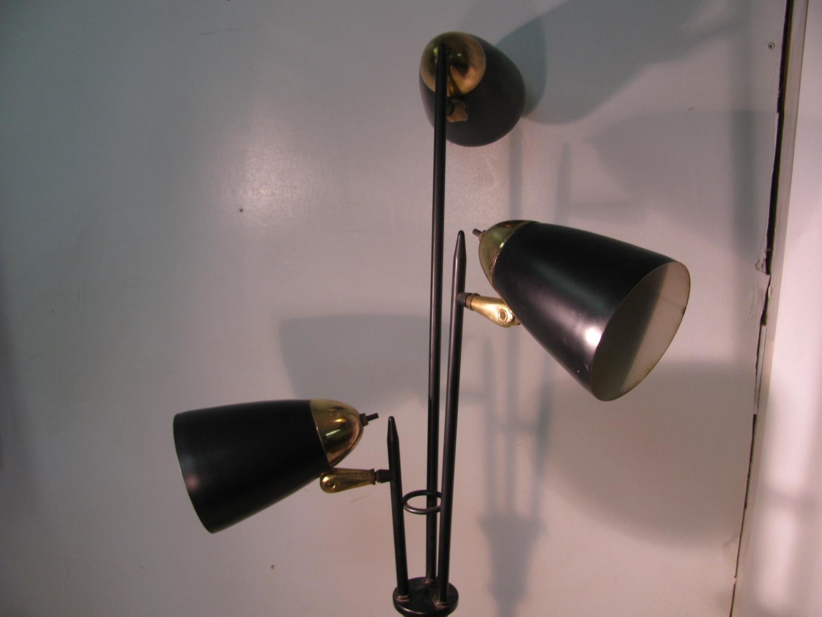 Timeless piece with 3 fully adjustable lamp heads to direct light wherever needed. Black with brass accents, sturdy and well balanced.