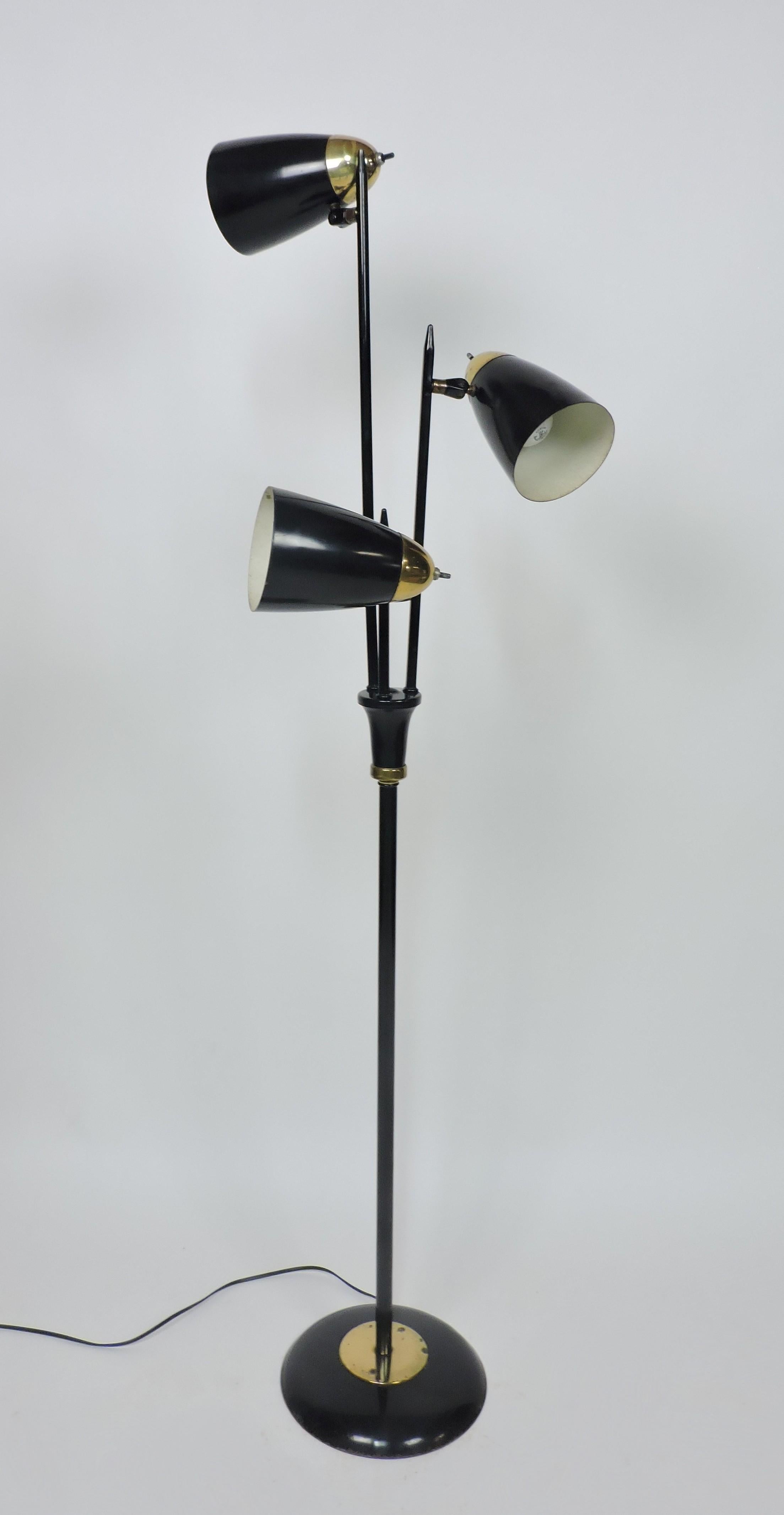 Classic Mid Century modern three headed floor lamp designed by Gerald Thurston and made by high quality manufacturer, Lightolier. This lamp has three bullet shaped shades with individual switches and can be adjusted in any direction for flexible