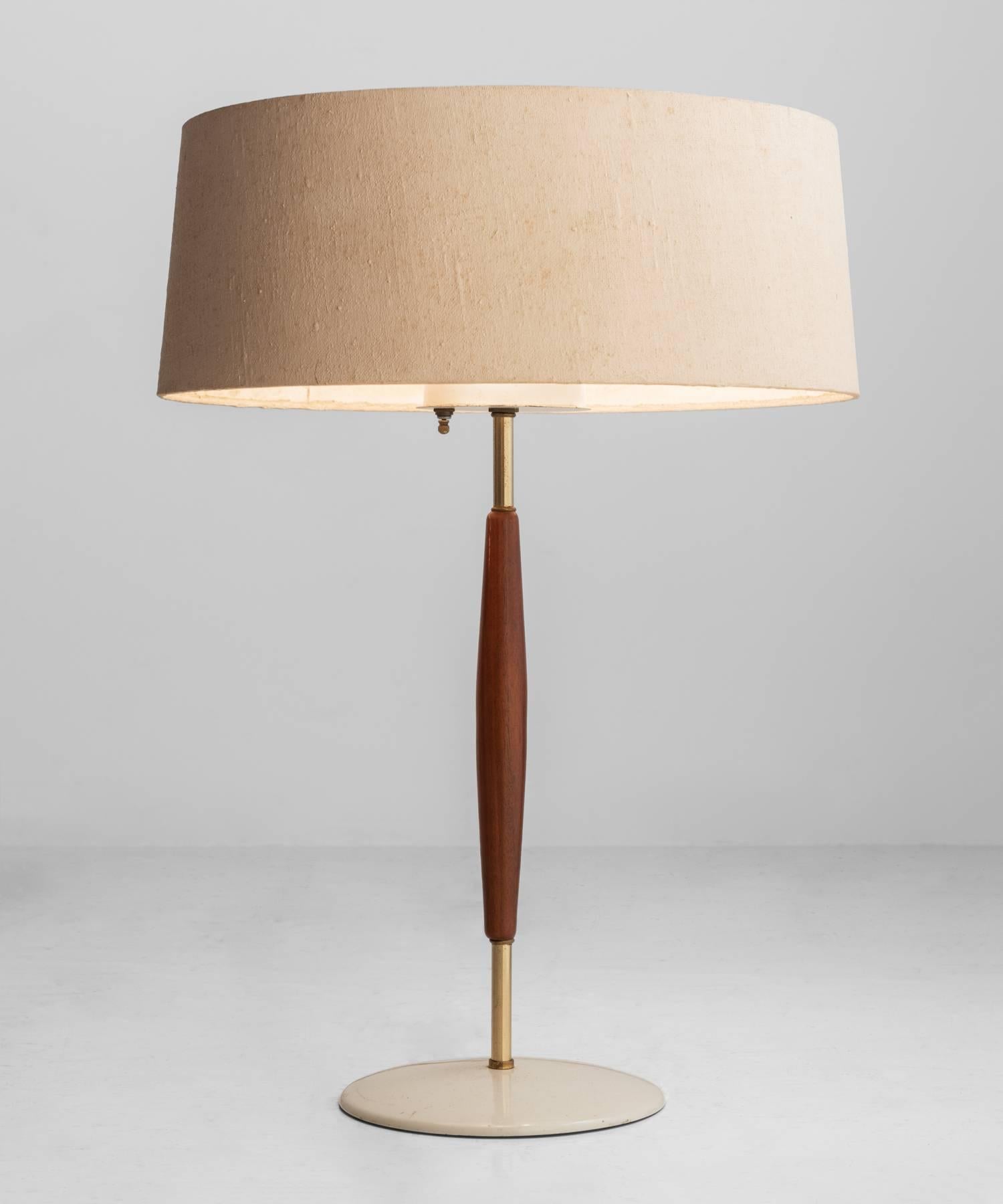 Gerald Thurston table lamp, America, circa 1960.

Linen wrapped shade with white steel diffuser, on walnut and brass base.