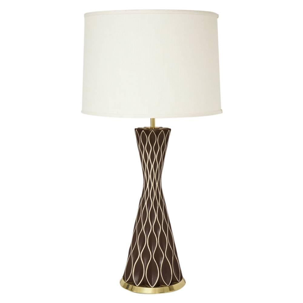 Gerald Thurston table lamps, porcelain, brass, brown, white. Pair of medium scale hourglass form lamps decorated with honeycomb patterns and glazed in chocolate brown with white piping. Porcelain bodies measure: 19 inches. Shades not included.