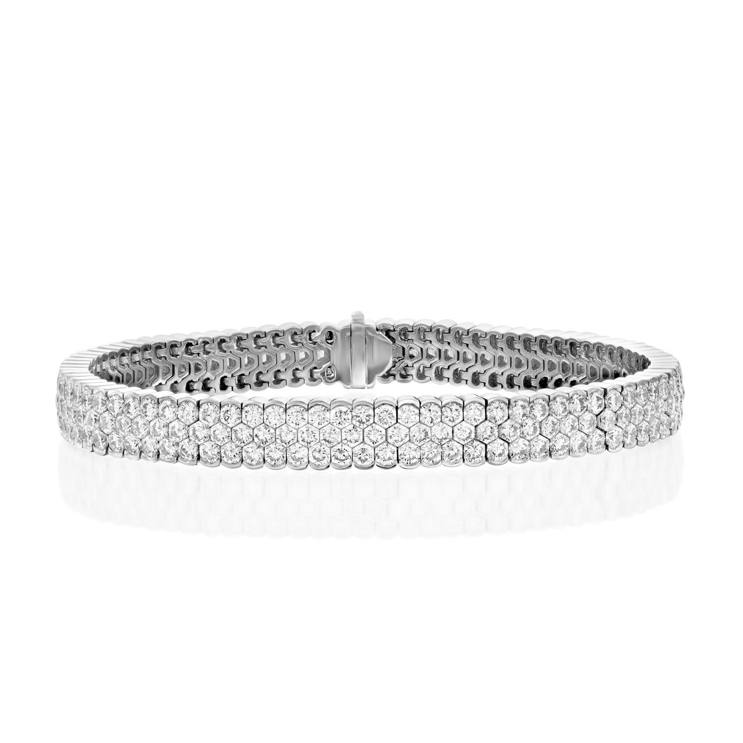 Experience the epitome of luxury with the Geraldo 14.2 Carat 3 Row Diamond White Gold Invisible Setting Bracelet, a true masterpiece of jewelry design. This stunning bracelet features a seamless design that showcases 14.2 carats of f/vs-vvs