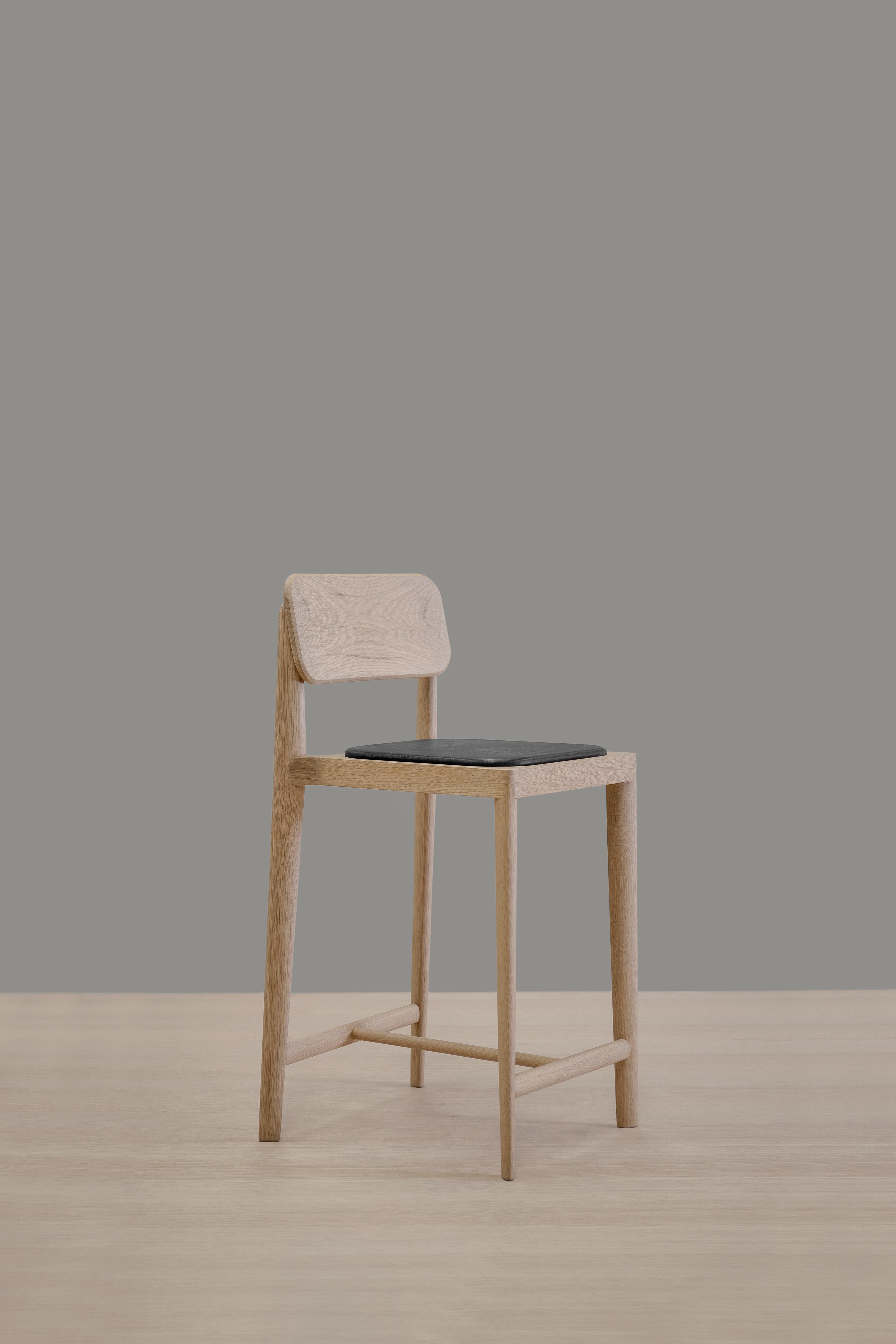 Gerard barstool by Thai Hua.
Dimensions: D 50 x W 48 x H 88 cm
Materials: oak wood, leather.

Solid holm white oak and black leather stool.

Thai Hua is an industrial designer originally from Vietnam trained in Switzerland. Since 2003 Thai Hua
