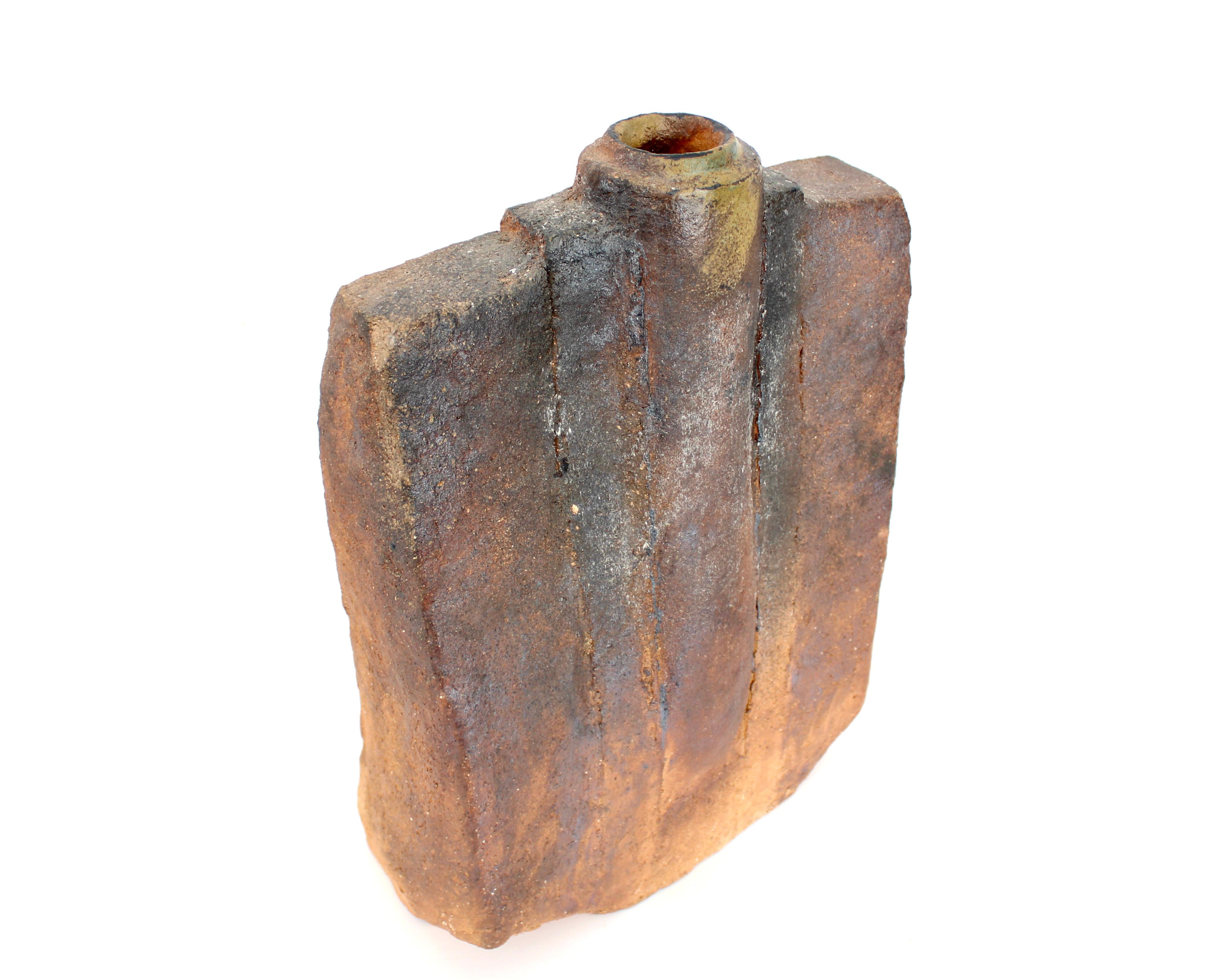 Jarrón de cerámica de gres natural cocido con madera, obra de Gérard Brossard, nacido en 1950. Se formó en la Escuela de Bellas Artes de Bourges y se especializó en cerámica con Jean y Jacqueline Lerat. Escultura monolítica de gres, esmaltes beige y