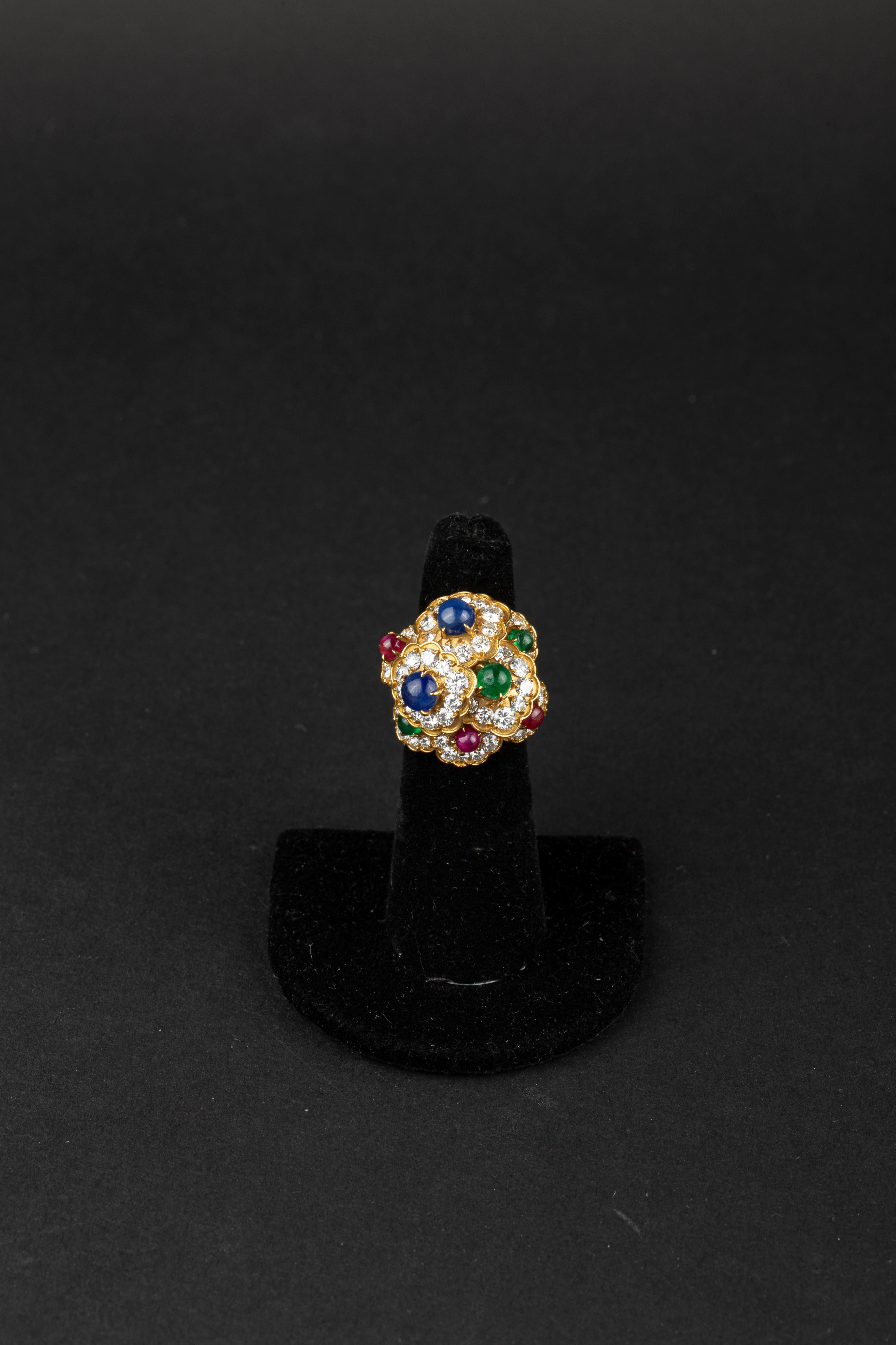 M. Gérard Gold, Cabochon Colored Stone and Diamond Floret Cluster Dome Ring Made in France, circa 1970.
18 kt., 8 round cabochon sapphires, rubies and emeralds, 78 round diamonds ap. 4.60 cts., signed M. Gérard, no. 5.72, with maker's mark and