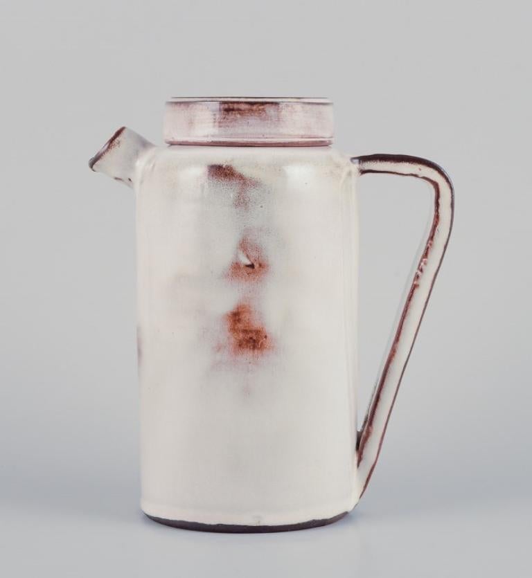 Gerard Hofmann (1917-1965), ceramista francés, taller propio. 
Cafetera de cerámica única. Esmalte en tonos tierra. Hecho a mano.
Alrededor de 1960.
En perfecto estado.
Firmado.
Dimensiones: A 20,0 cm x P 17,0 cm, incluido el pico y el asa.