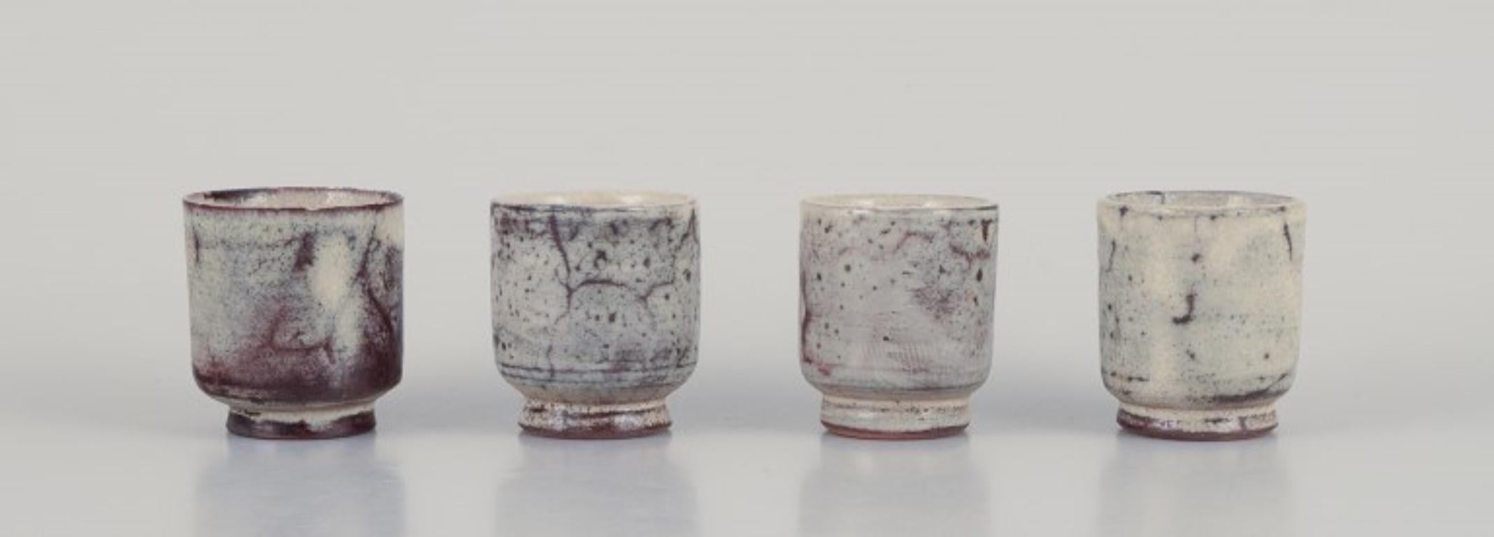 Gerard Hofmann (1917-1965), French ceramicist, own workshop. 
A set of four small cups. Unique ceramics. Earth-toned glaze. Handmade.
Circa 1960.
In excellent condition.
Dimensions: H 5.5 cm x D 4.5 cm.