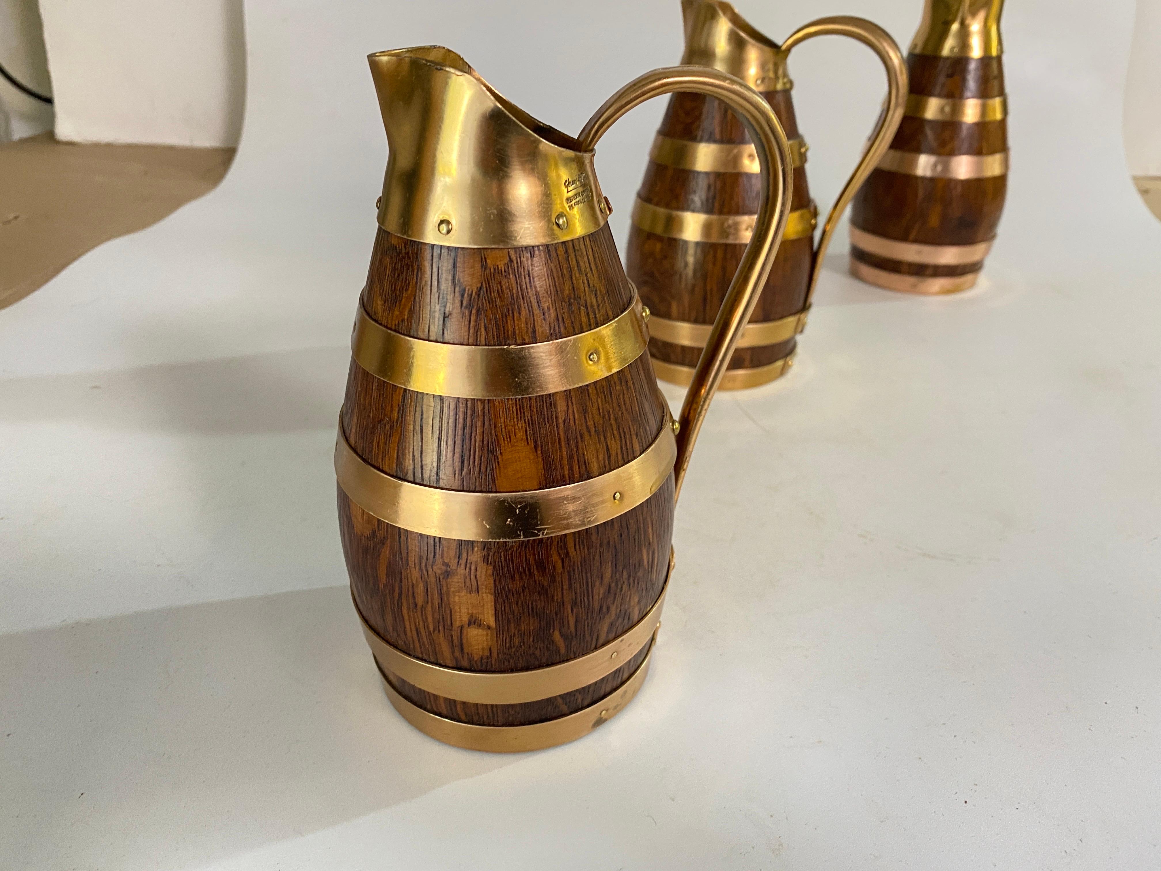 Superb 1933, Set of three Brass banded, oak barrels. This beautiful wine or cider jugs were created by Gérard Lafitte, selected as Meilleur Ouvrier de France (one of the best workers in France) an annual trade award started in 1924 given to master