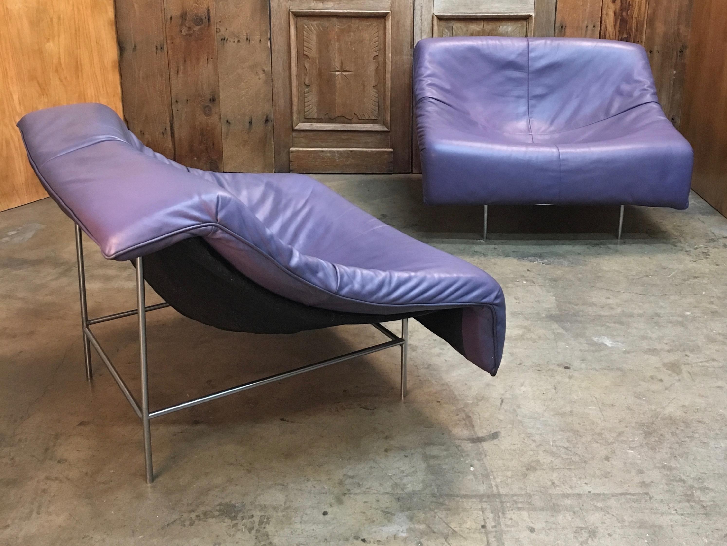 Gerard Van Den Berg butterfly chairs with plum crazy leather that rest upon a black mesh and chrome-plated steel legs.
