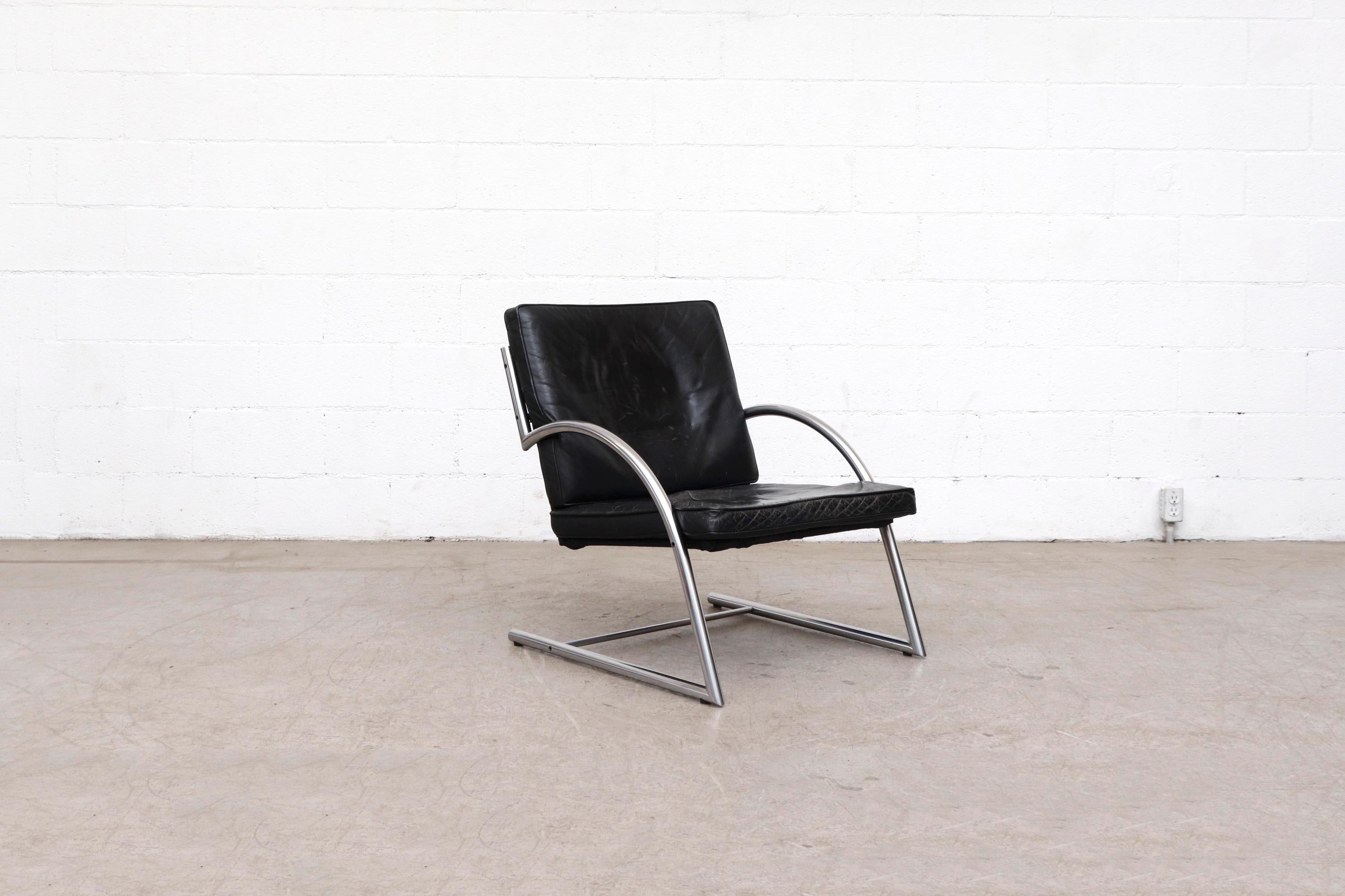Mid-century black leather Des lounge chairs with tubular chrome frame. Woven black rattan back and seat with black leather cushions in original condition with visible wear. 