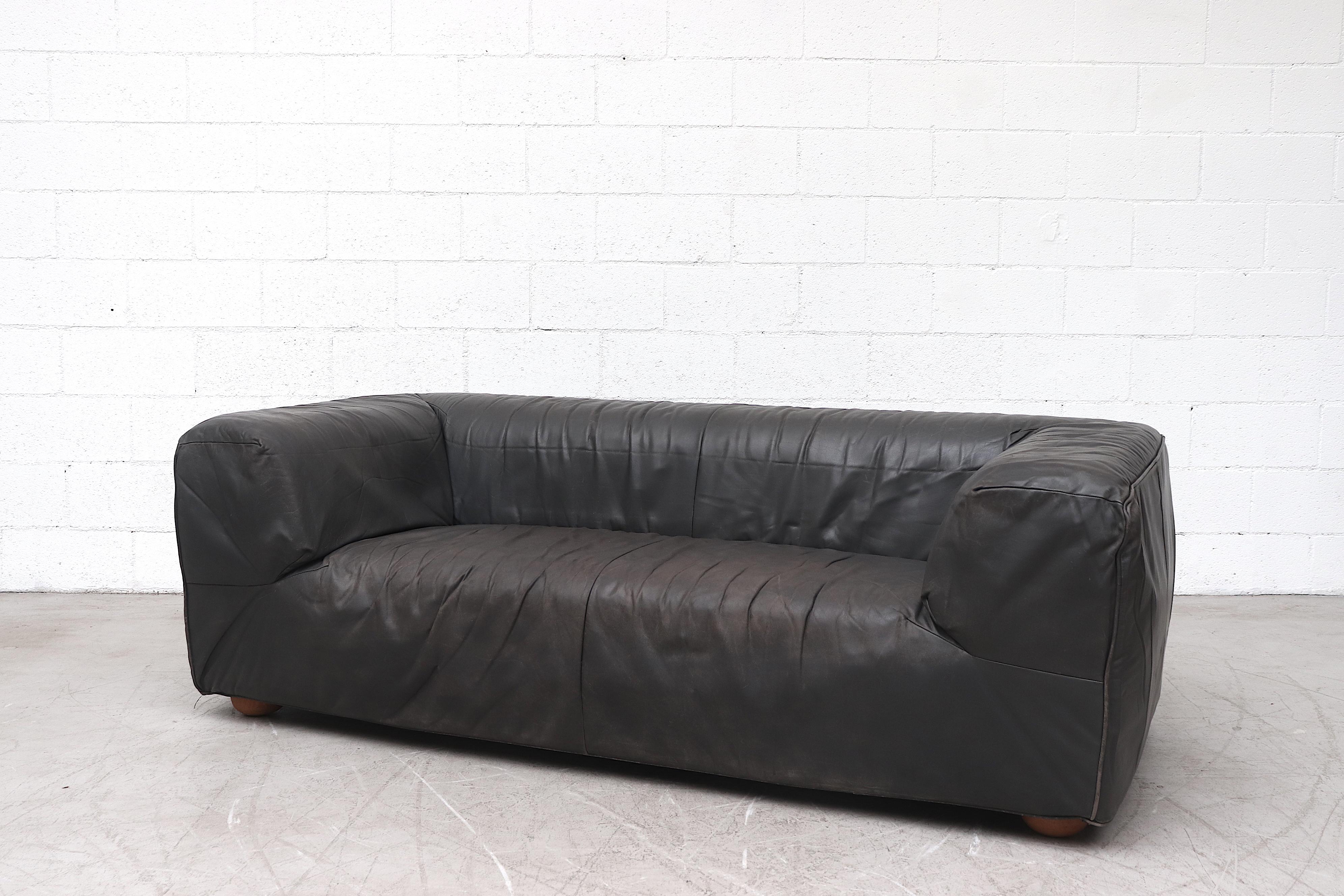 Beautiful 1980s well worn handsome dark grey leather sofa by Gerard Van Den Berg for Montis with original tag. Comfortable soft structure sofa on round wood feet. In original condition with visible wear and patina.