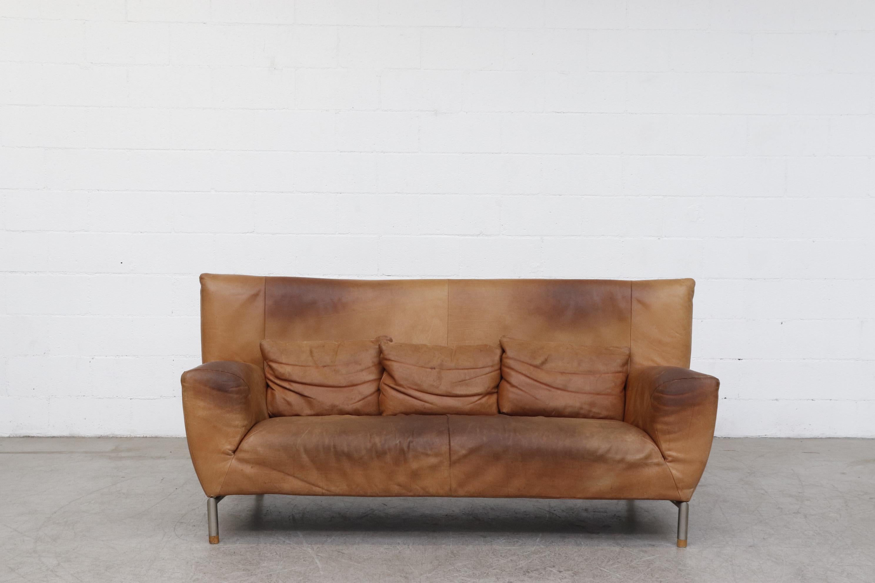 Modern Gerard Van Den Berg high back natural leather sofa with tubular metal legs and wood foot caps and 3 matching pillows. Visible natural patina. In original condition with wear consistent with its age and usage. Color may vary slightly from