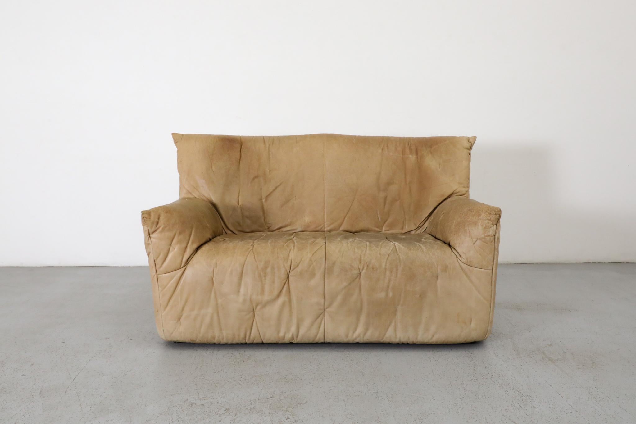 Very unusual Gerard van den Berg natural leather high back loveseat with light tufting details throughout the piece creating a subtle pattern. The expression of this piece is in it's innovative pillow-shaped design, and its simplicity of form. A few